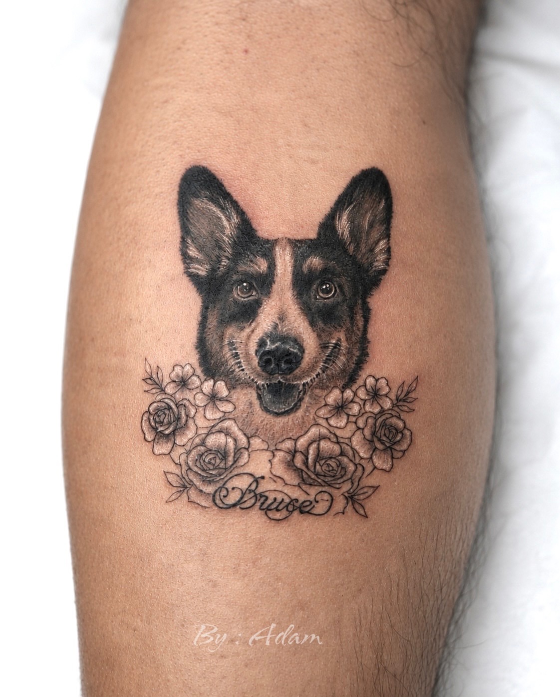 Dog with floral wreath realism tattoo on the forearm by Adam_Zhiwei Xu(Tattooist)