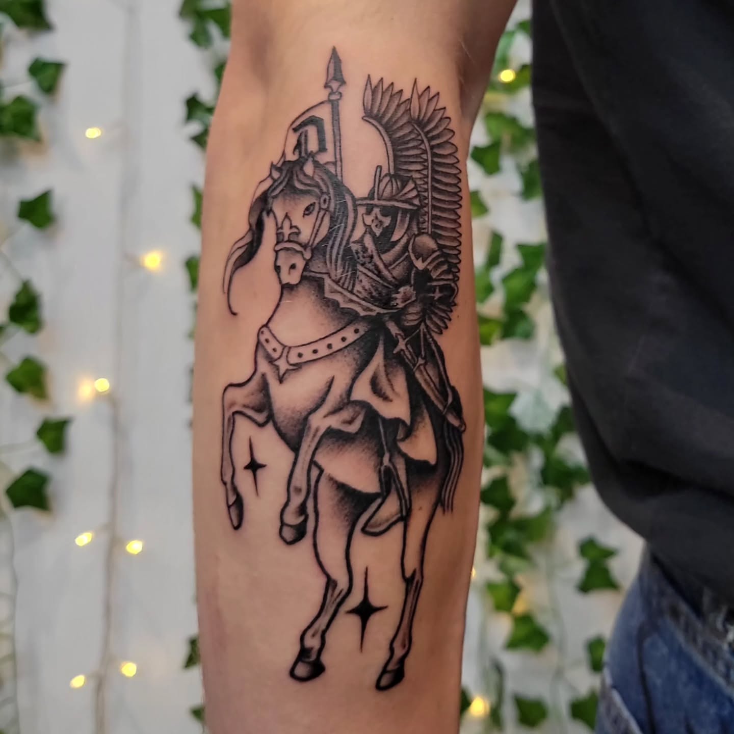 Horse and rider black and grey tattoo on the forearm by Uku Tattoos, Cambridge, England