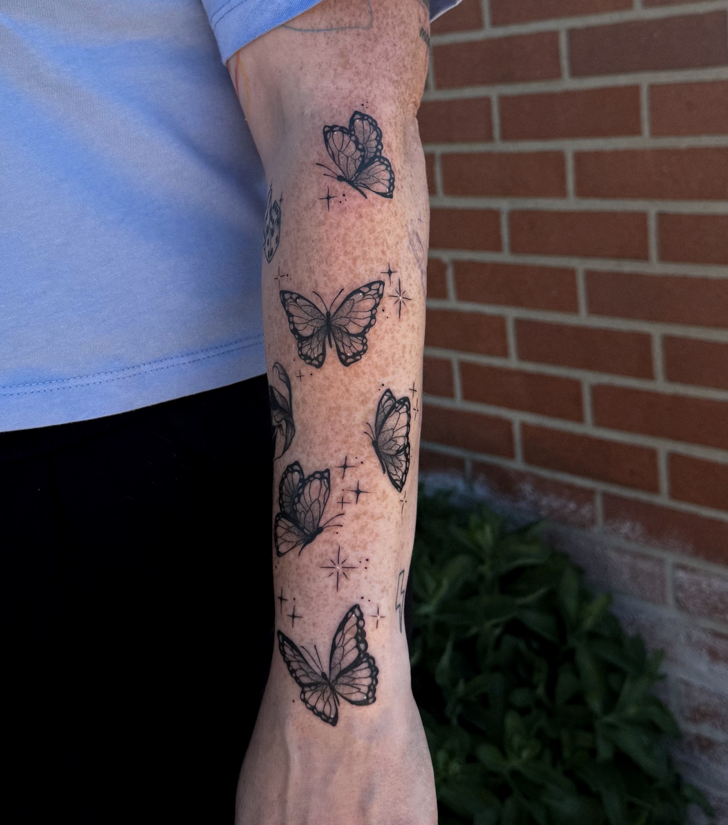 Butterflies dotwork tattoo on the forearm by Jessica Bloom