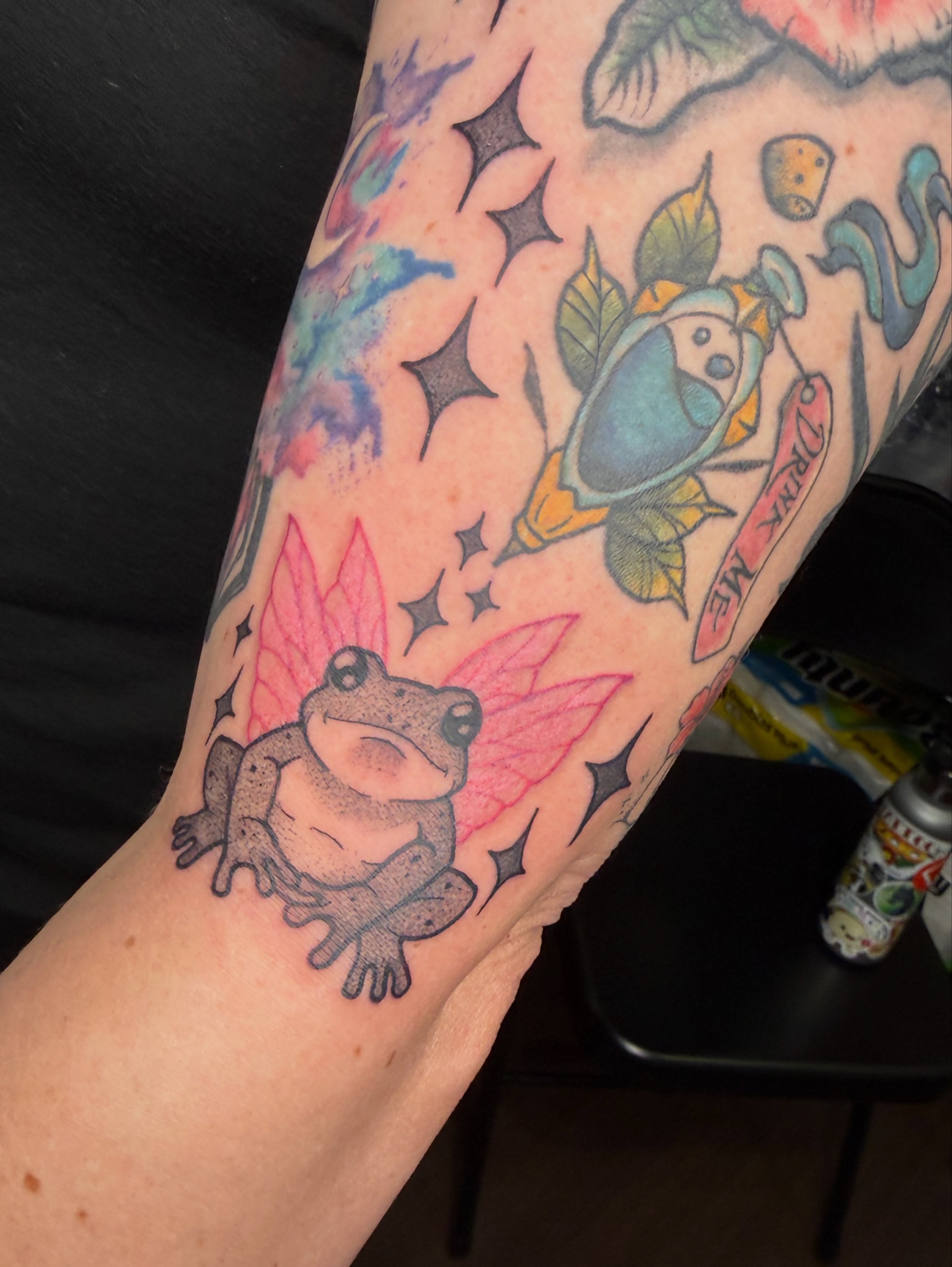 Frogs and mushrooms American traditional tattoo on the forearm by Jezza Munson