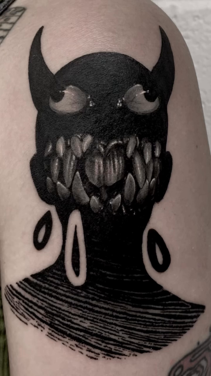 Demonic figure with sharp teeth dark art tattoo on the forearm by @lil_stinker_5000, Portland, Oregon