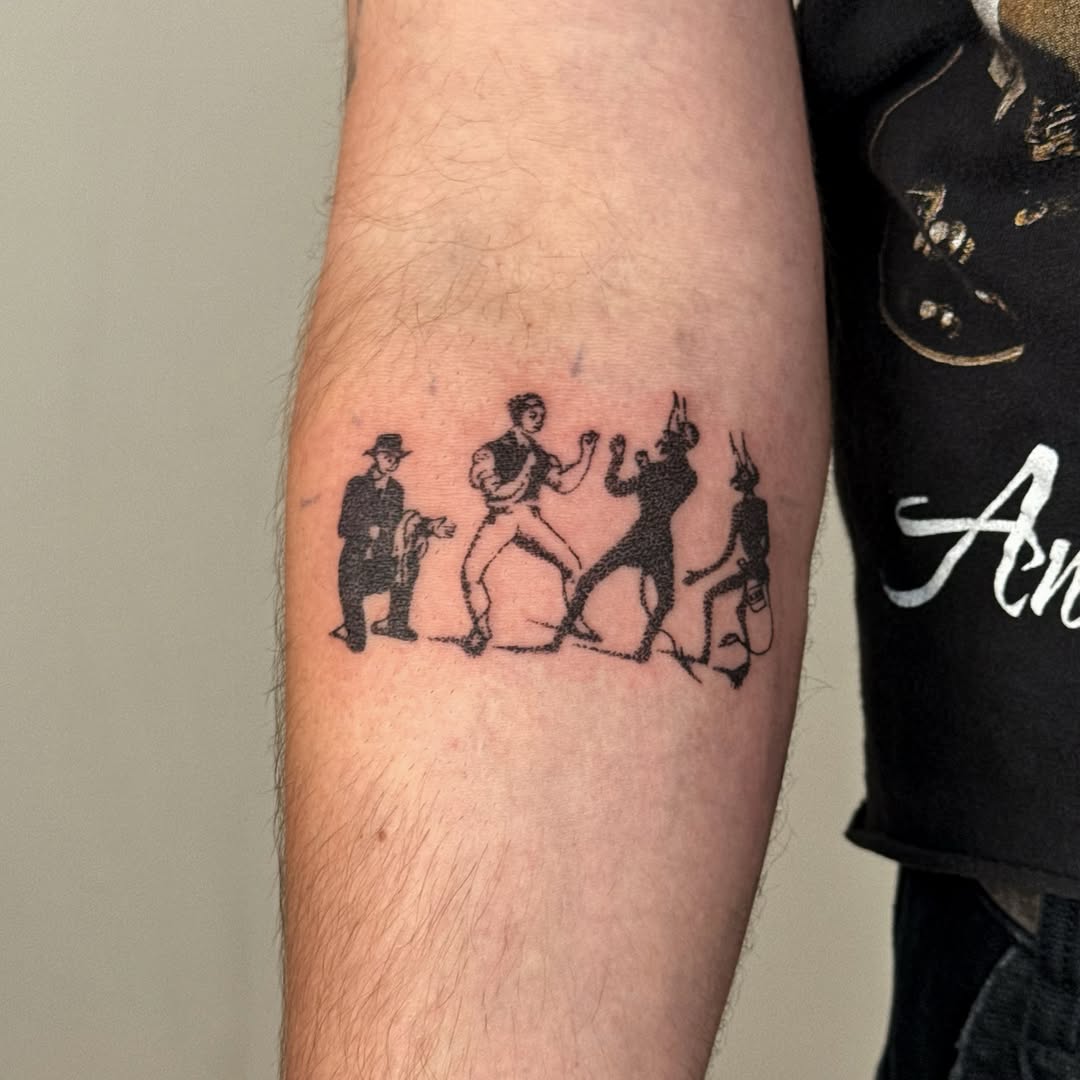 Four figures in a line tattoo on the forearm by Joint Killer