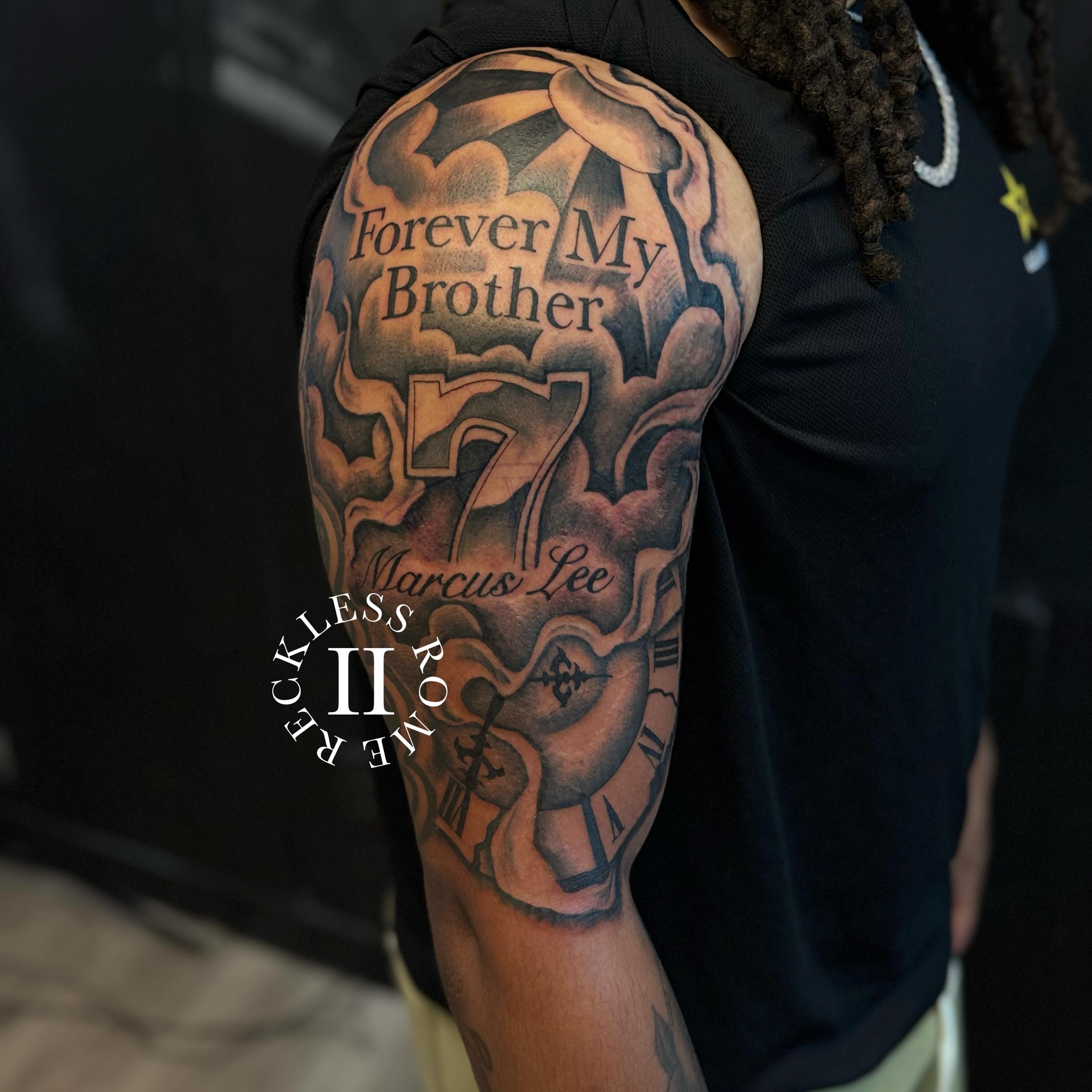 Forever My Brother black and grey tattoo on the upper arm by Rome