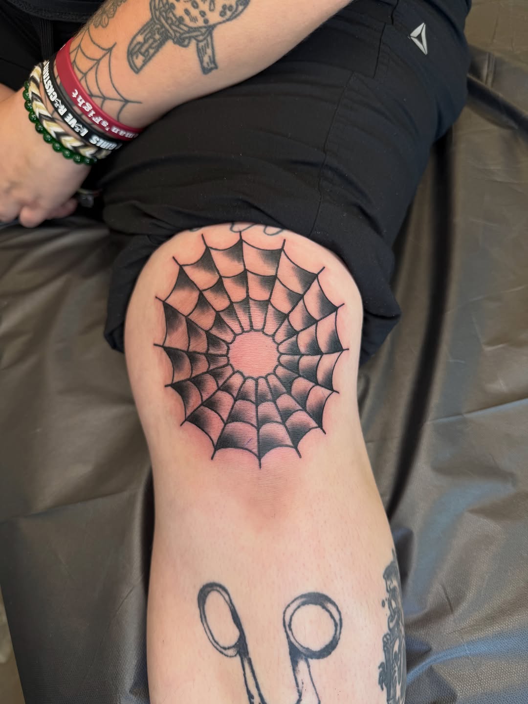 Spider web on knee tattoo on the thigh by Ricky Sanchez, Duncanville, Texas