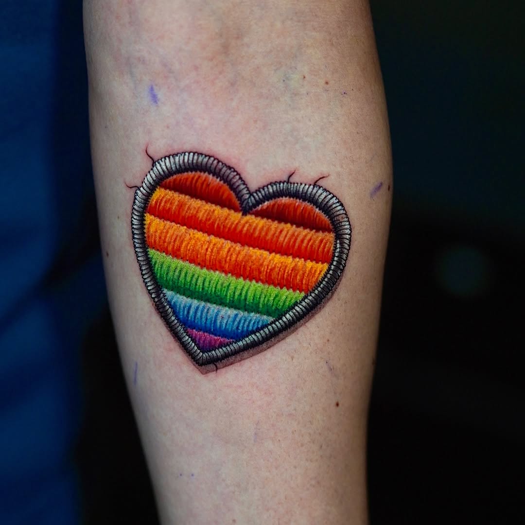 Embroidered heart patch new school tattoo on the forearm by Yana Aizen