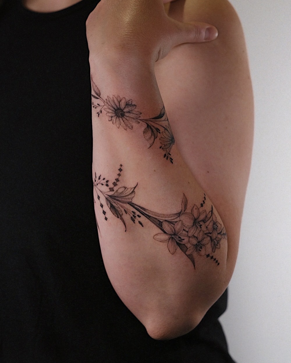 Floral arrangement black and grey tattoo on the forearm by Temple Adorned Tattoo