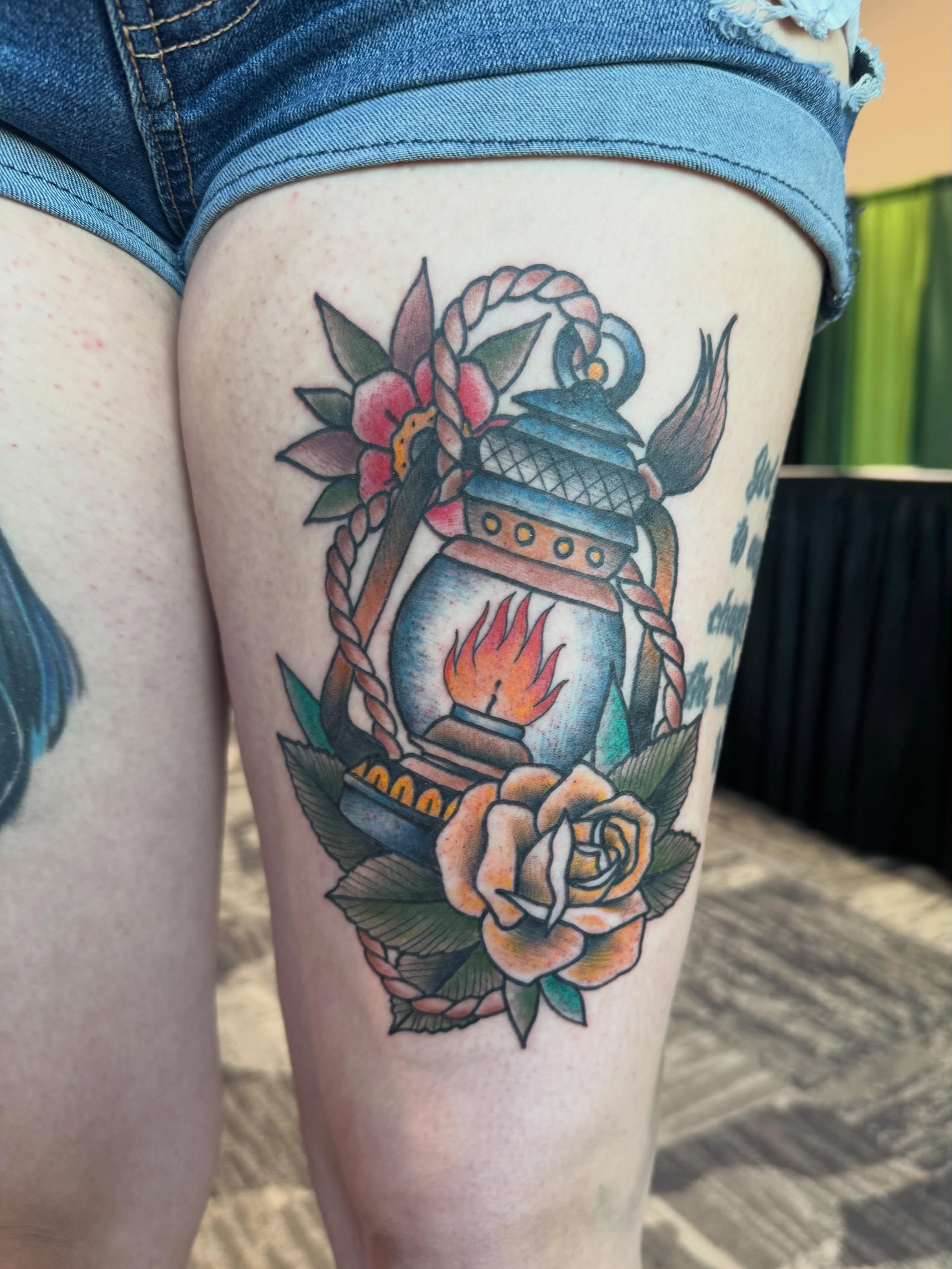 Lantern and rose American traditional tattoo on the thigh by Kyle Ketzler