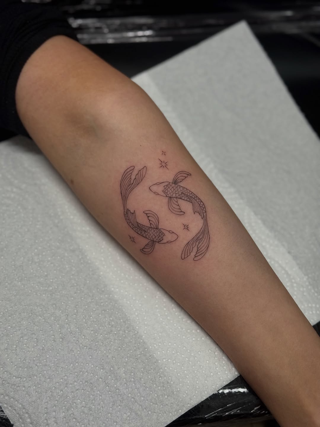 Two koi fish fine line tattoo on the forearm by Jules Ink ⋆ Fineline Tattoo