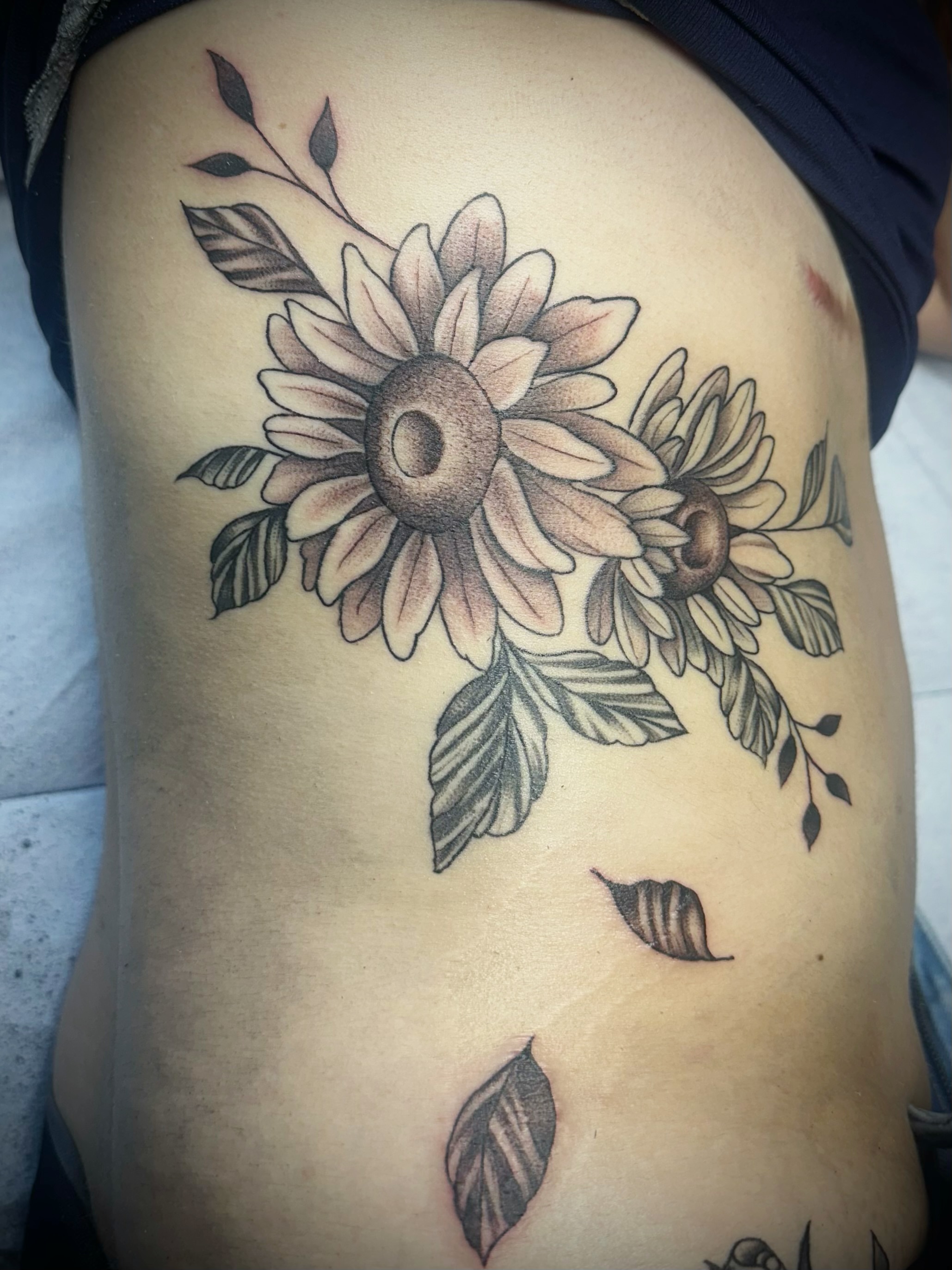 Sunflower bouquet black and grey tattoo on the ribs by 🥀Chloe Miller