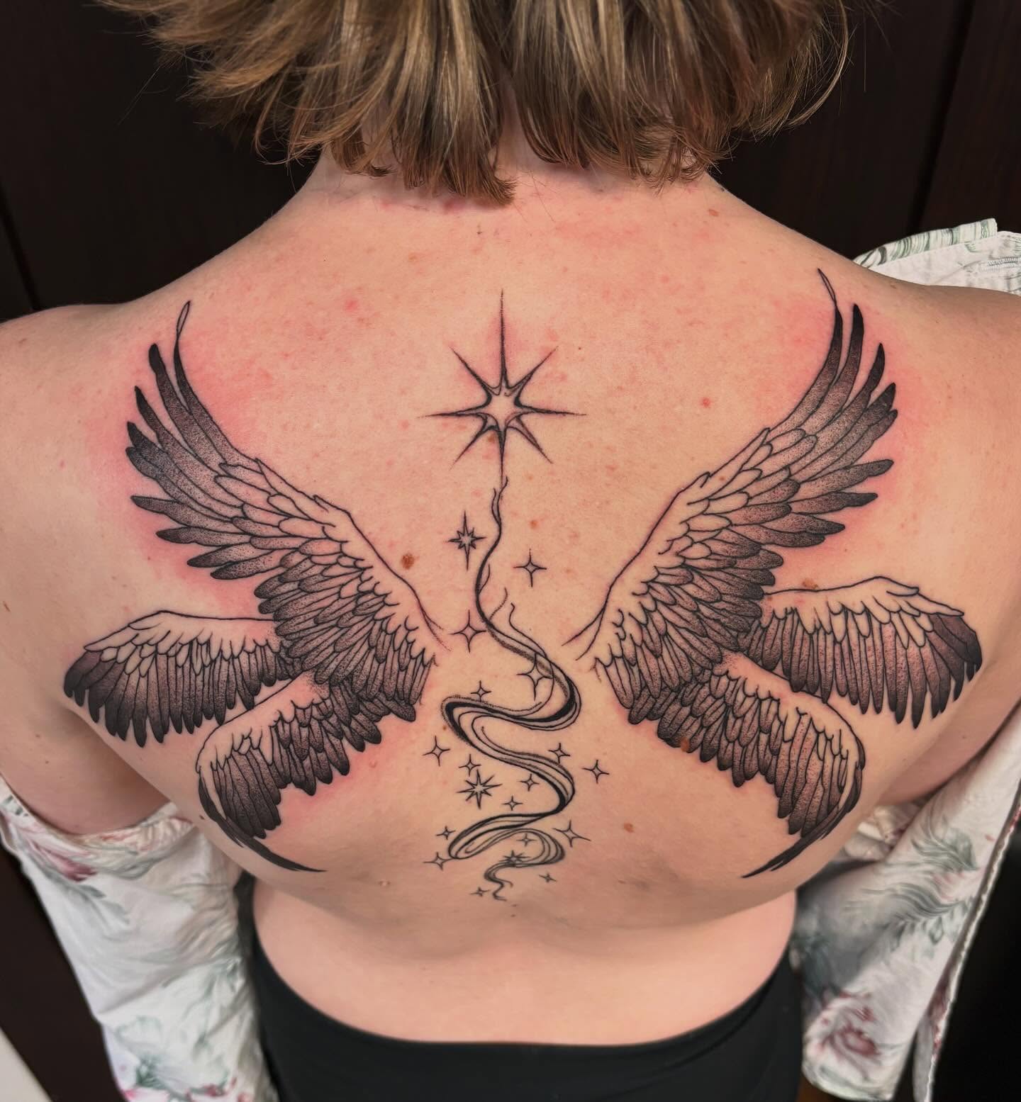Wings and stars black and grey tattoo on the back by kane