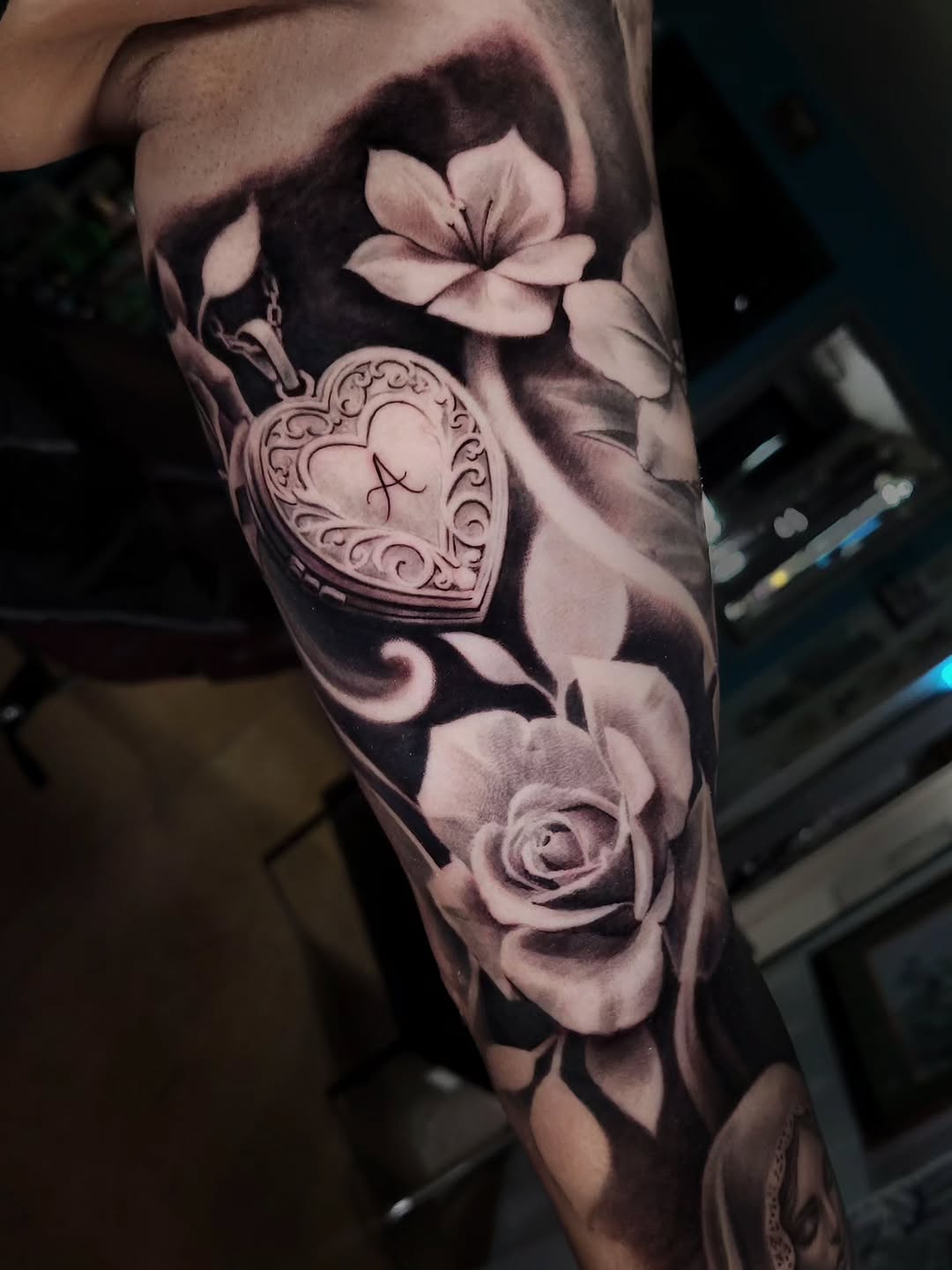 Heart locket and roses Chicano tattoo on the forearm by Brandon Rabago, Fort Worth, Texas