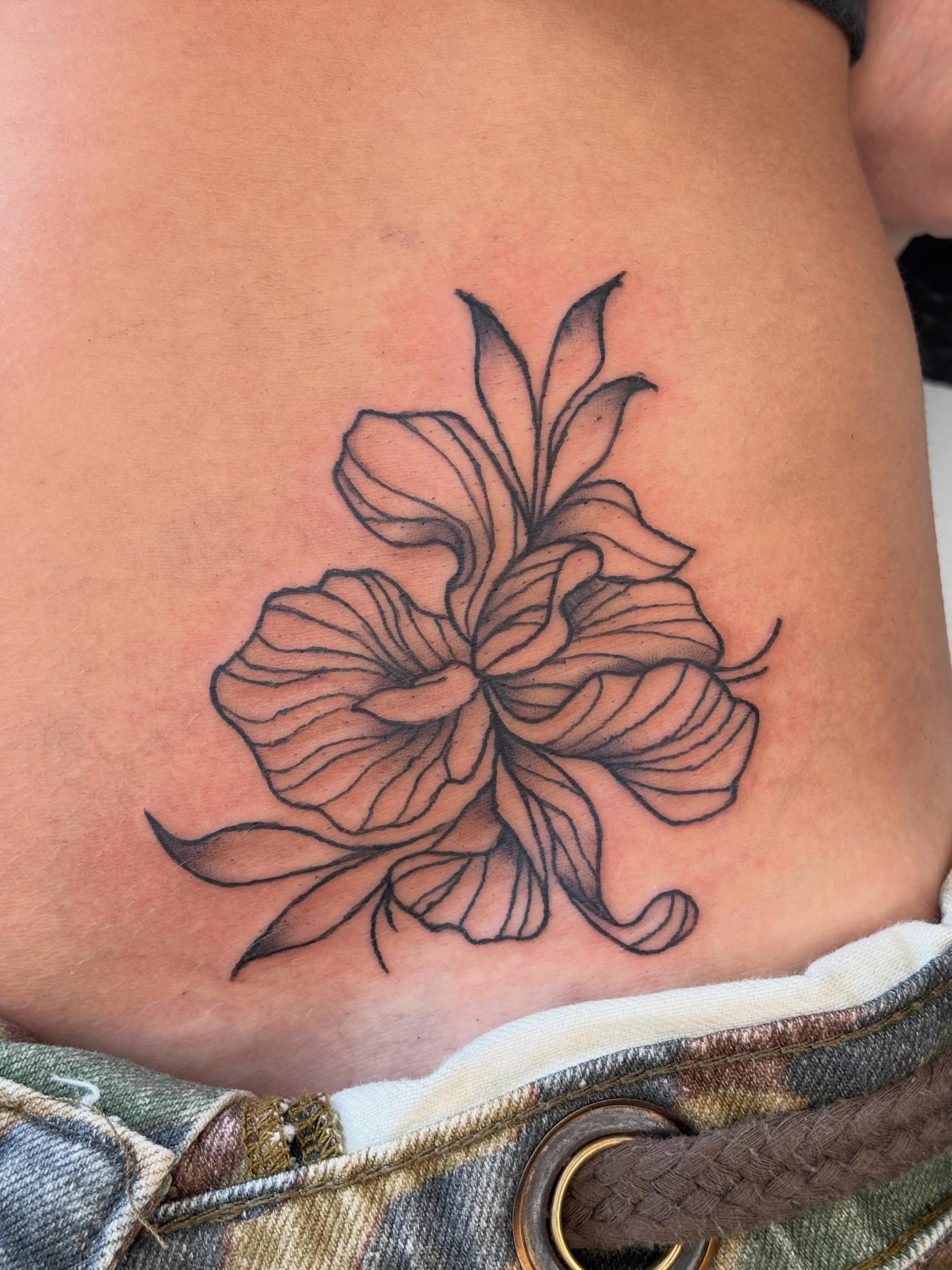 Lily black and grey tattoo on the ribs by Topher Belmont