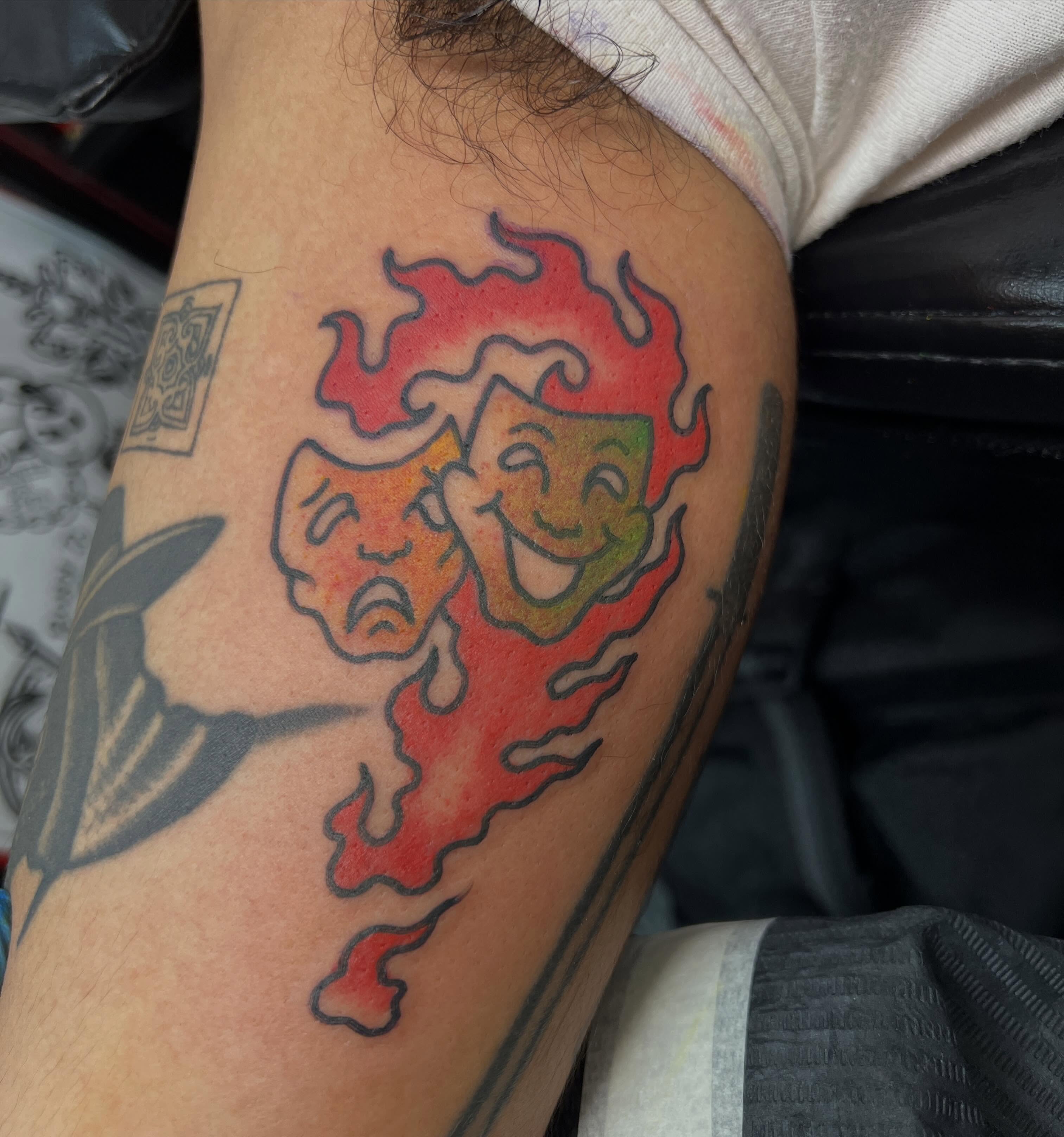 Theater masks American traditional tattoo on the forearm by Mat Helton, Fairborn, Ohio