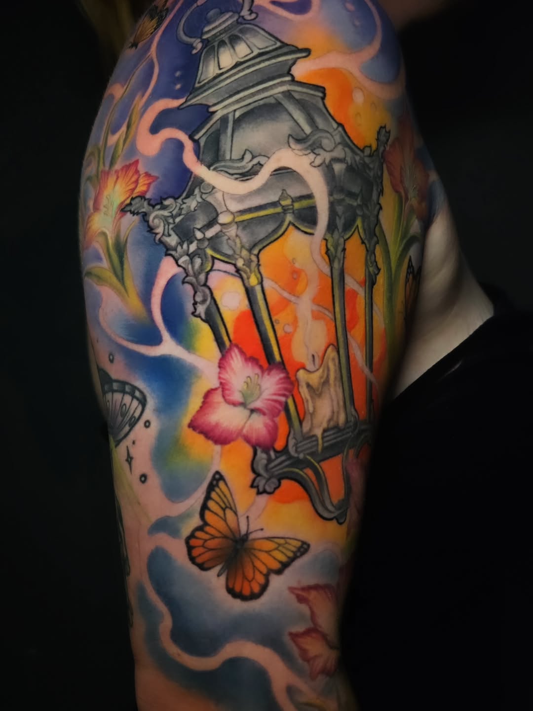 Lantern with flowers and butterflies watercolor tattoo on the forearm by Adriannah Esparza