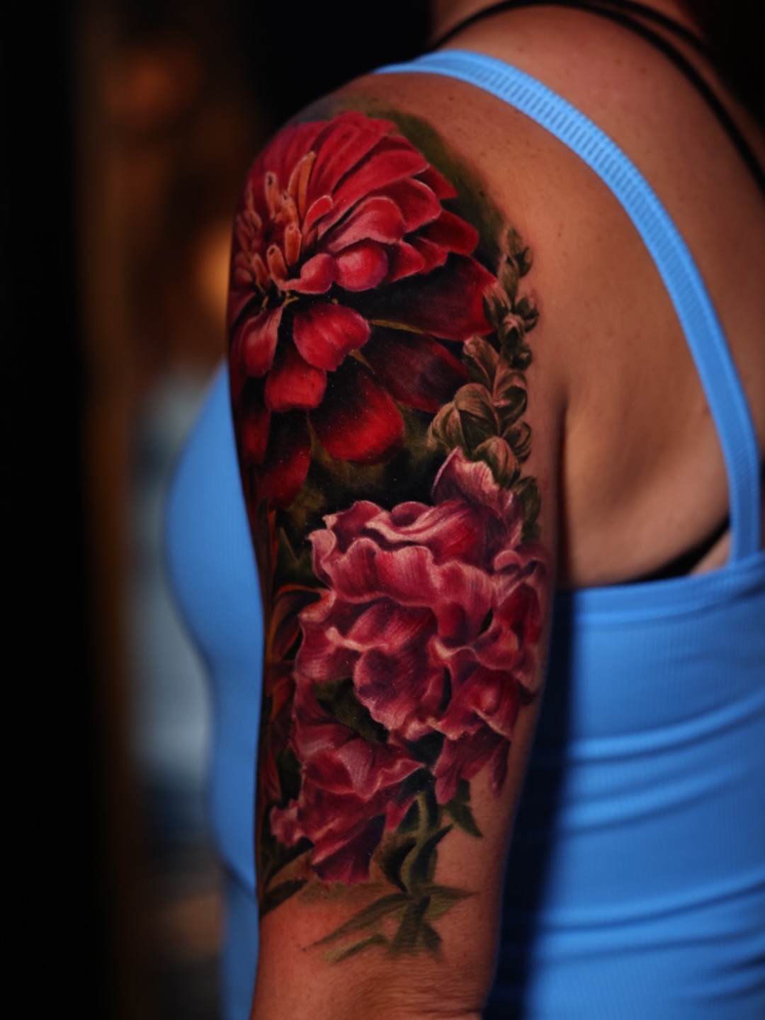 Floral bouquet realism tattoo on the upper arm by Brandon Sontag