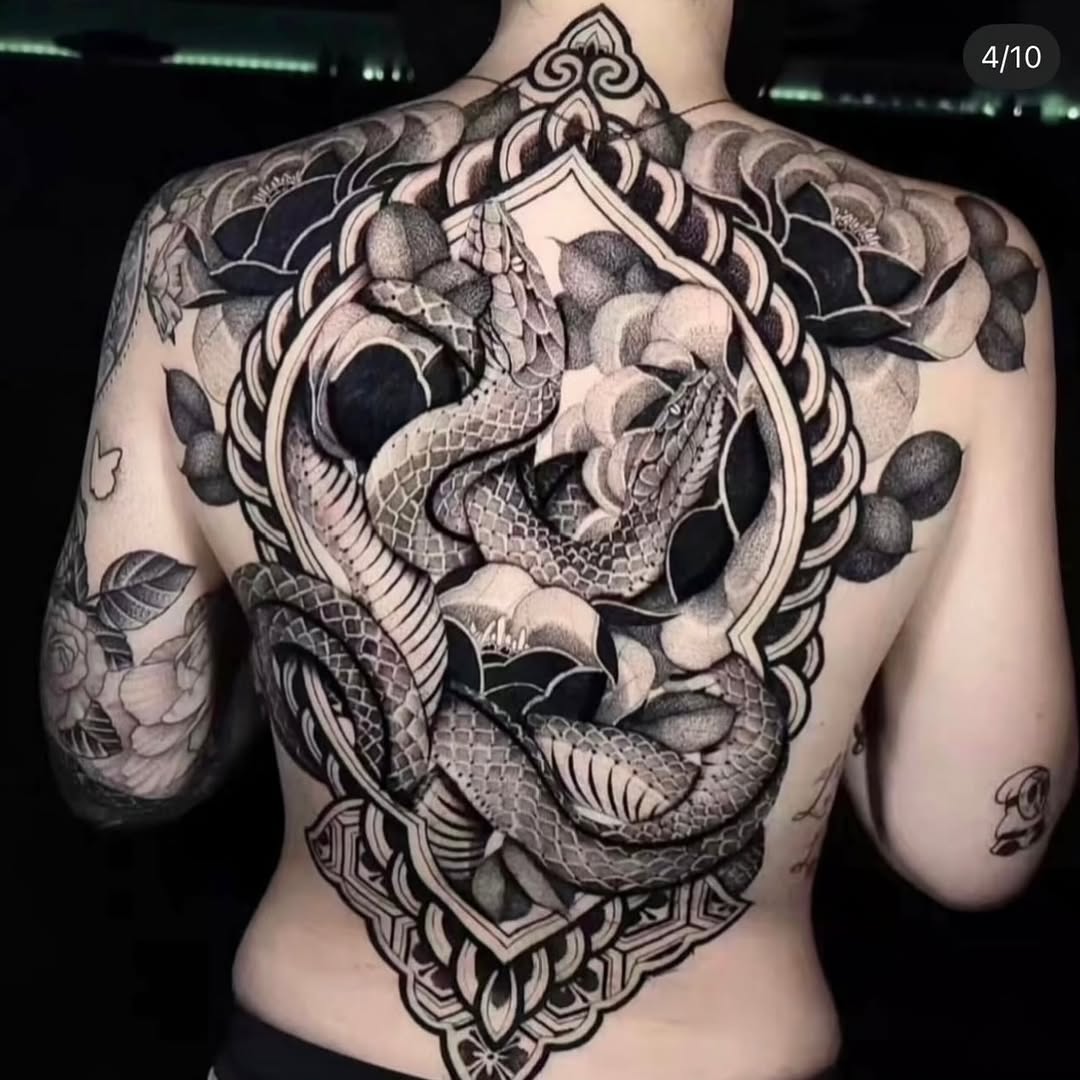 Snakes in ornate frame with flowers geometric tattoo on the back by miami tattoo artist
