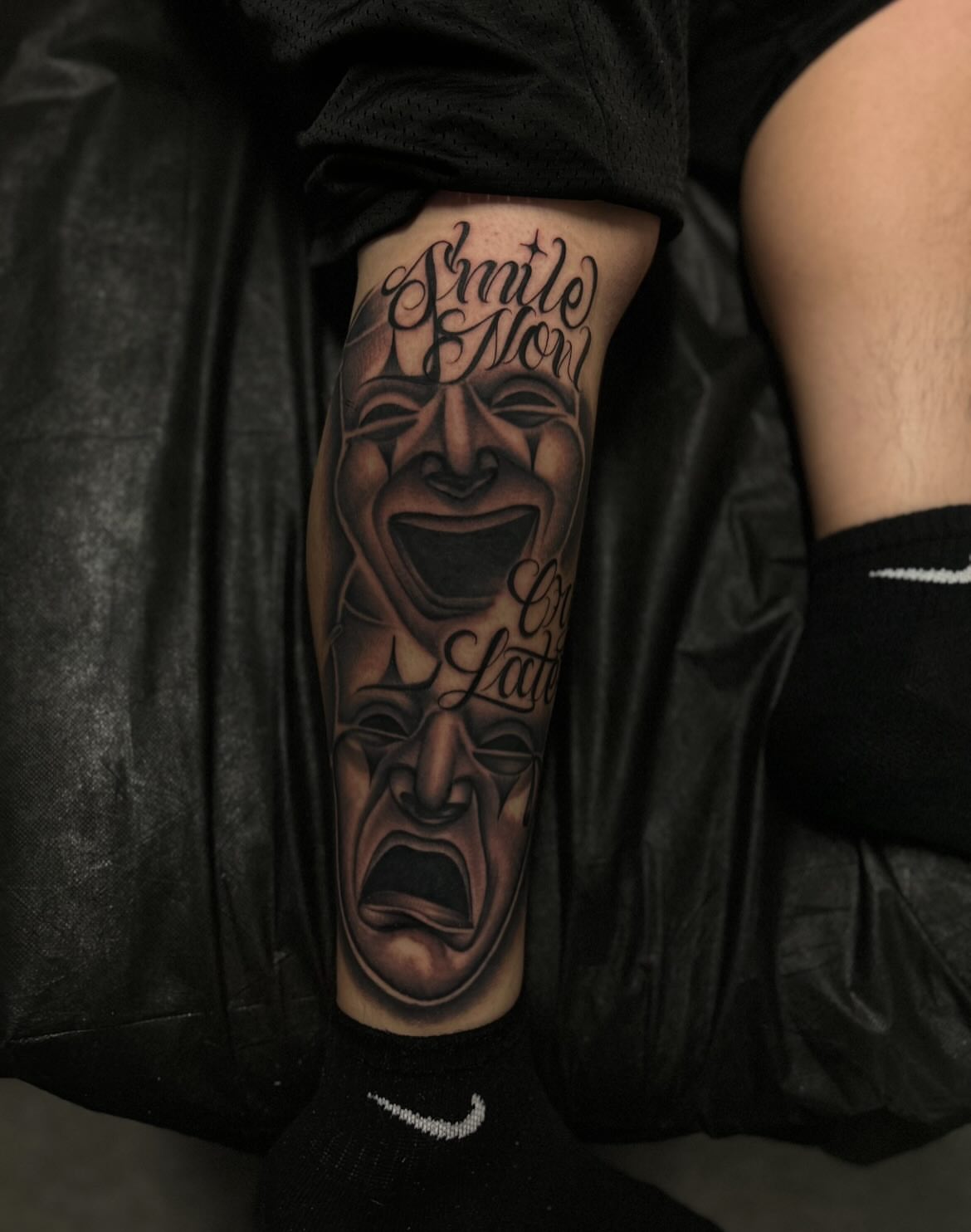 Theater masks realism tattoo on the forearm by Tattoo Artist
