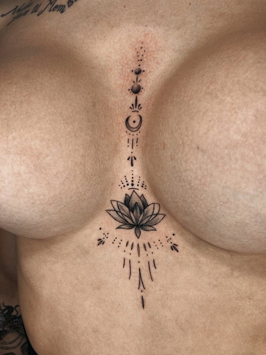 Lotus flower with celestial elements ornamental tattoo on the chest by Alvaro