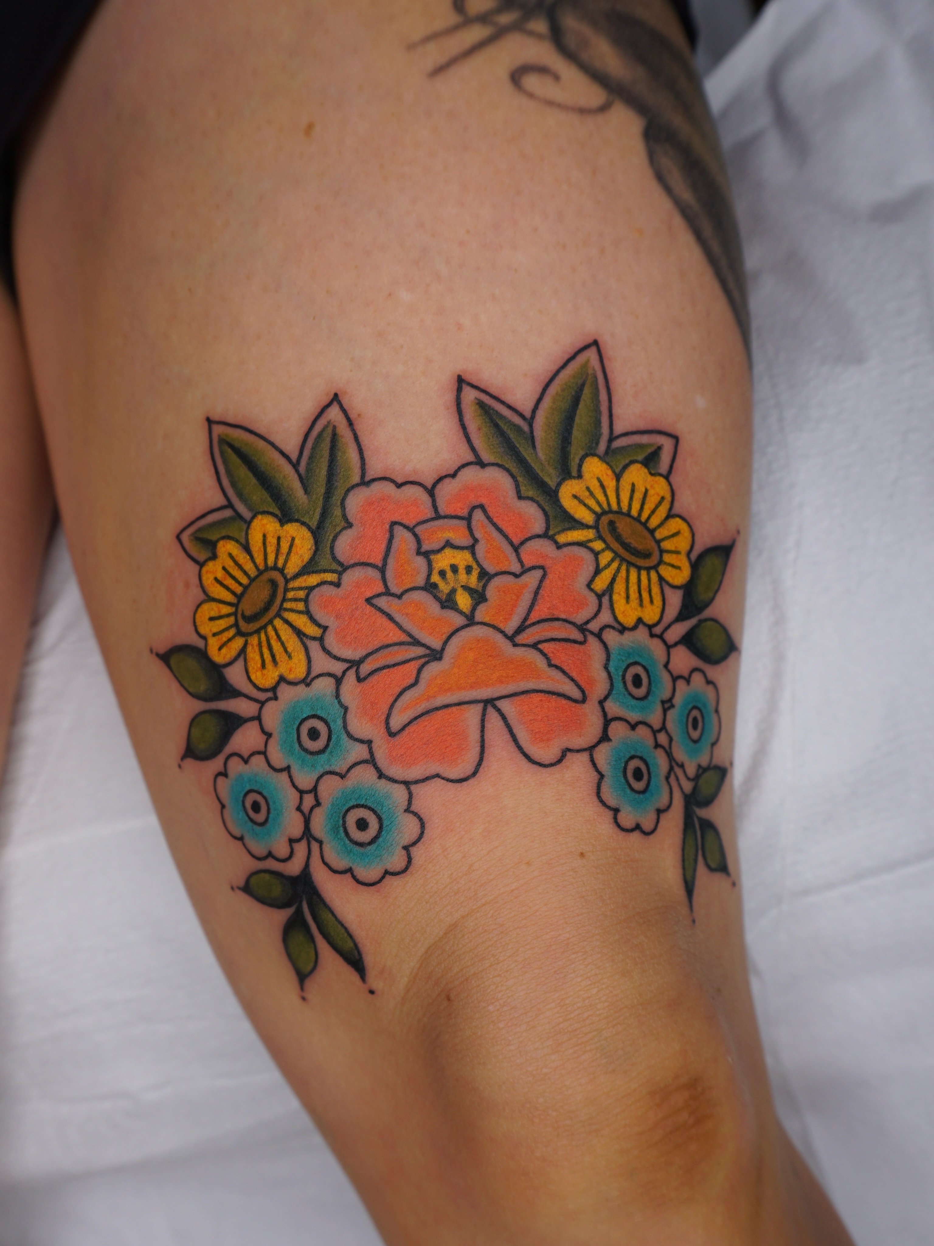 Floral bouquet American traditional tattoo on the forearm by Sarah Christine Tattoo, Calgary, Alberta