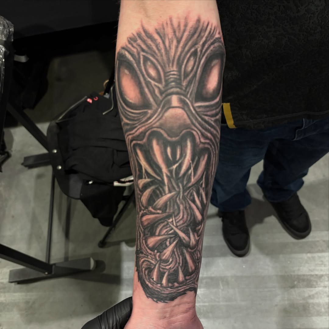 Alien mask realism tattoo on the forearm by Jack Ferreri