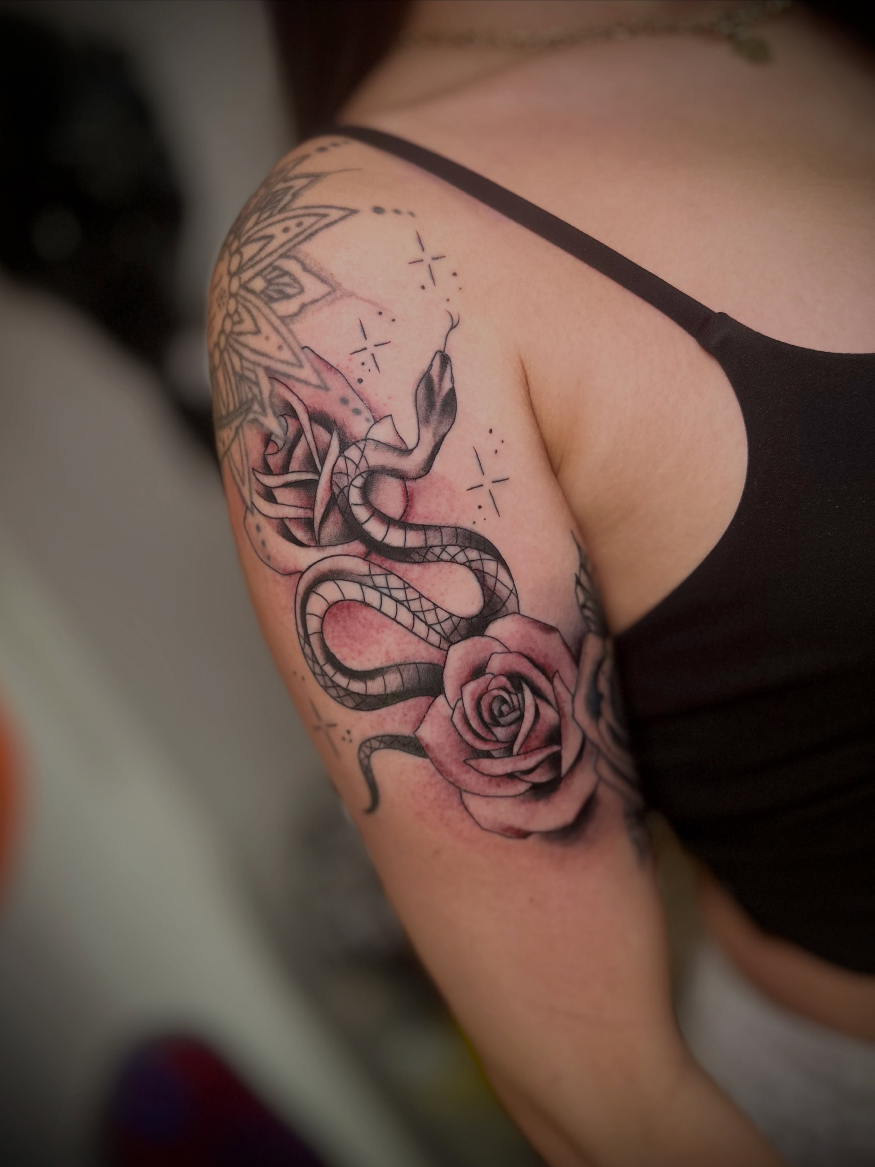 Snake and rose dotwork tattoo on the shoulder by @tatt2st