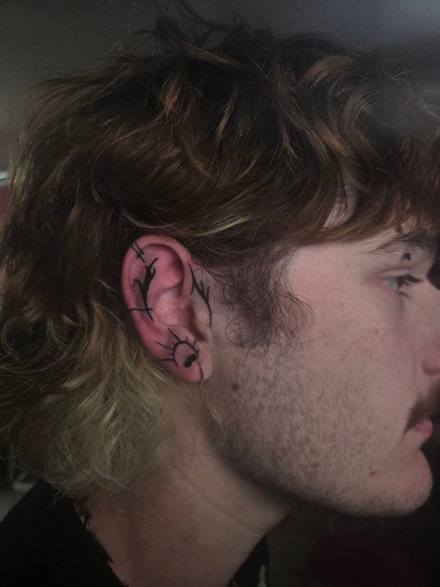 Ear tattoo black and grey tattoo by Lane
