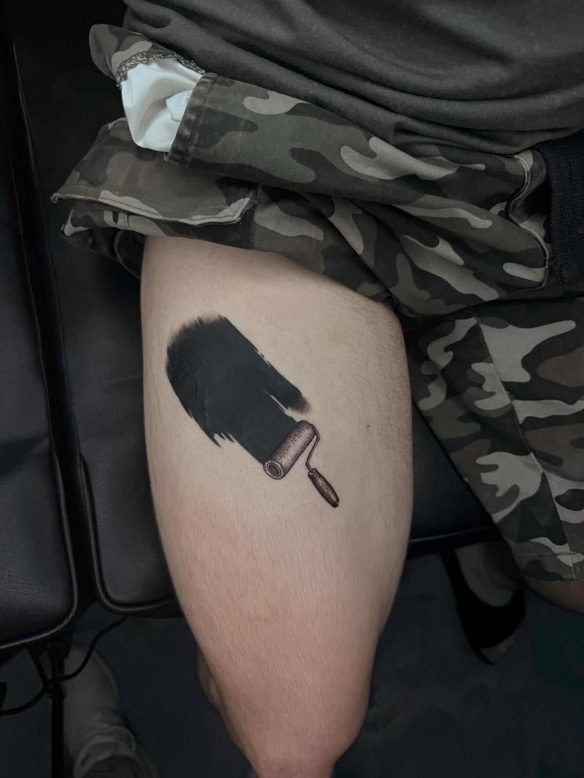 Paint roller and brush stroke realism tattoo on the thigh by Exis LHinc, Miami, Florida
