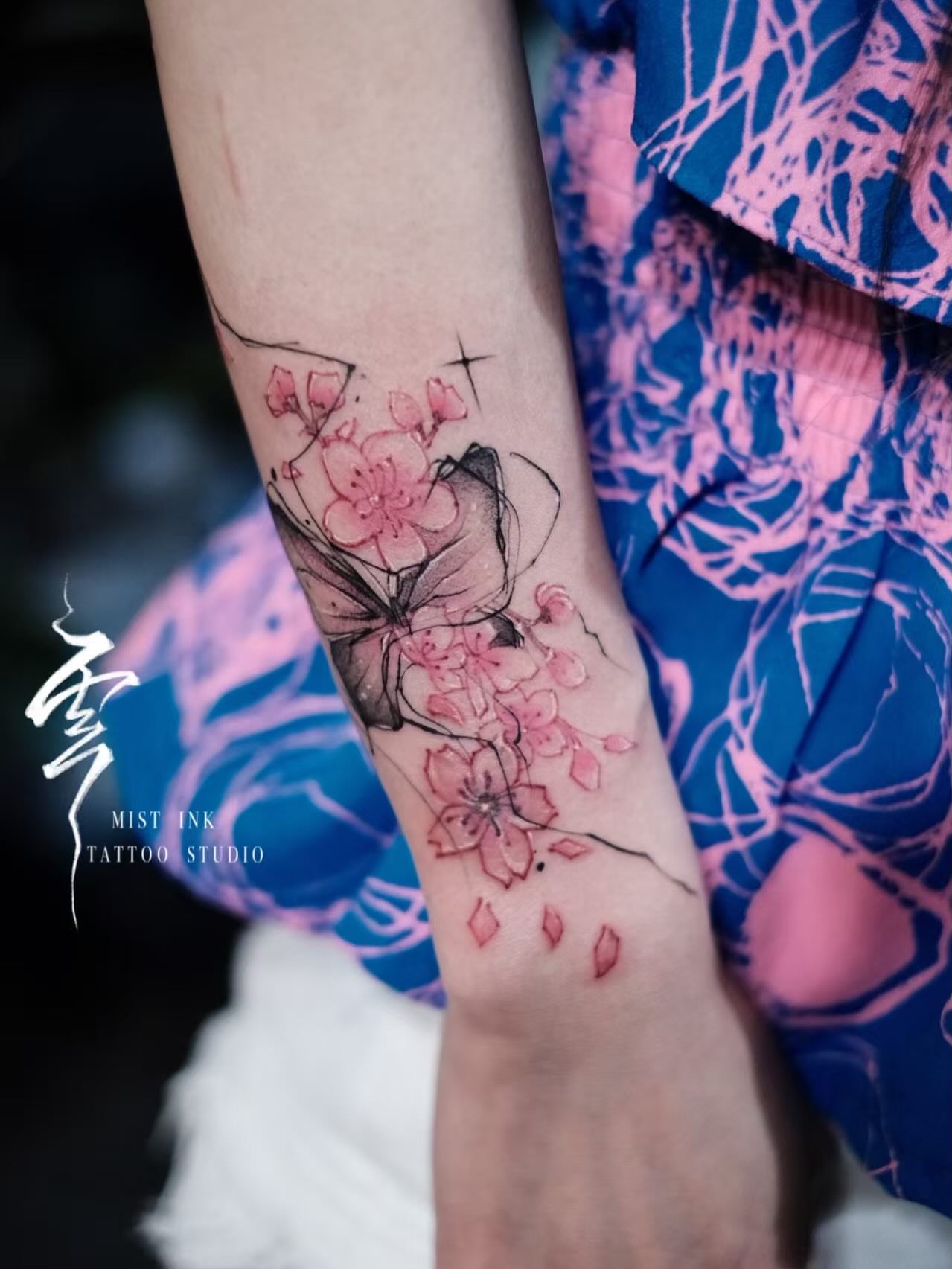Cherry blossoms and butterfly watercolor tattoo on the forearm by Ink _daisy_