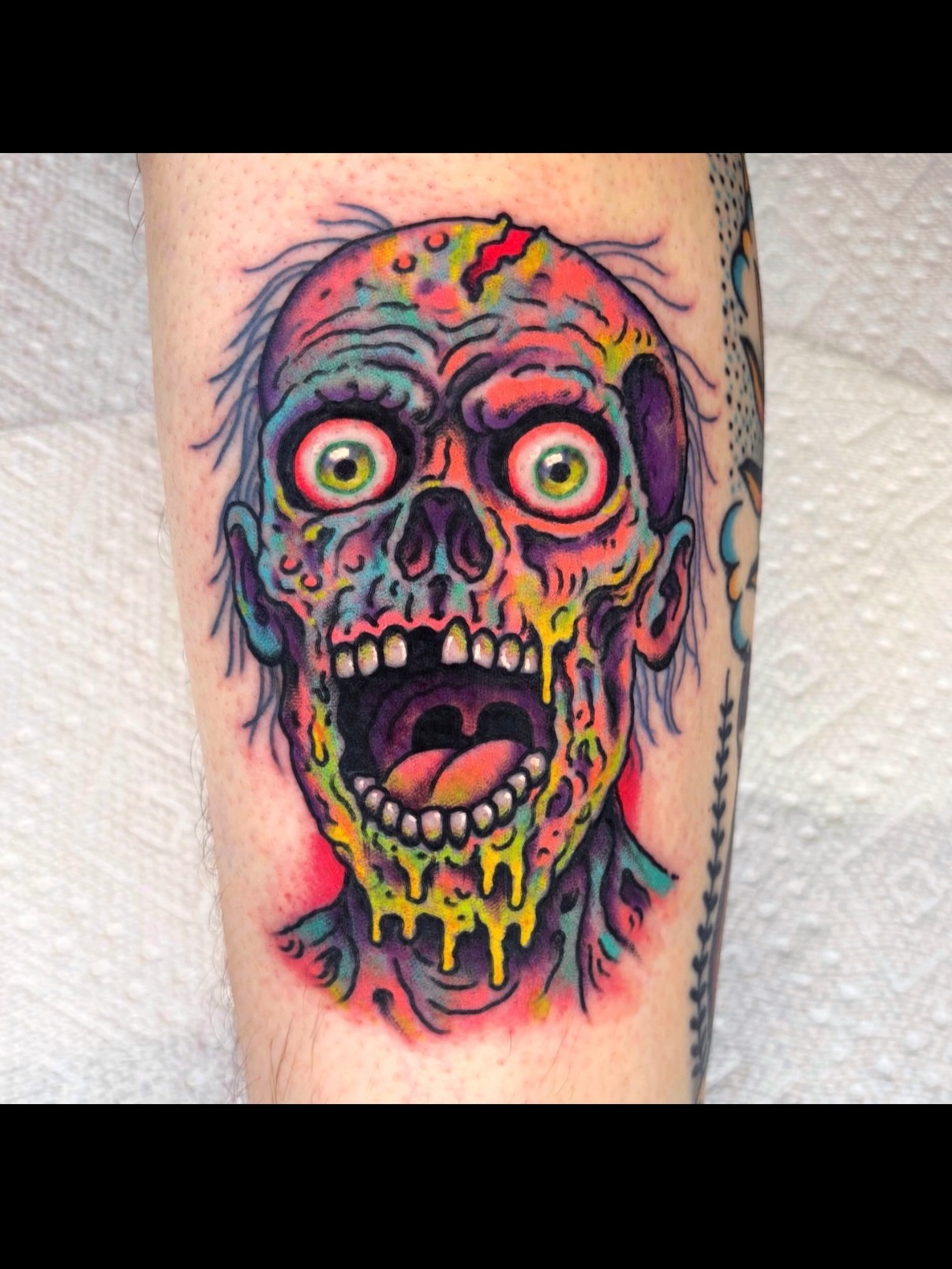 Zombie skull American traditional tattoo on the forearm by Randy Conner, Portland, Oregon