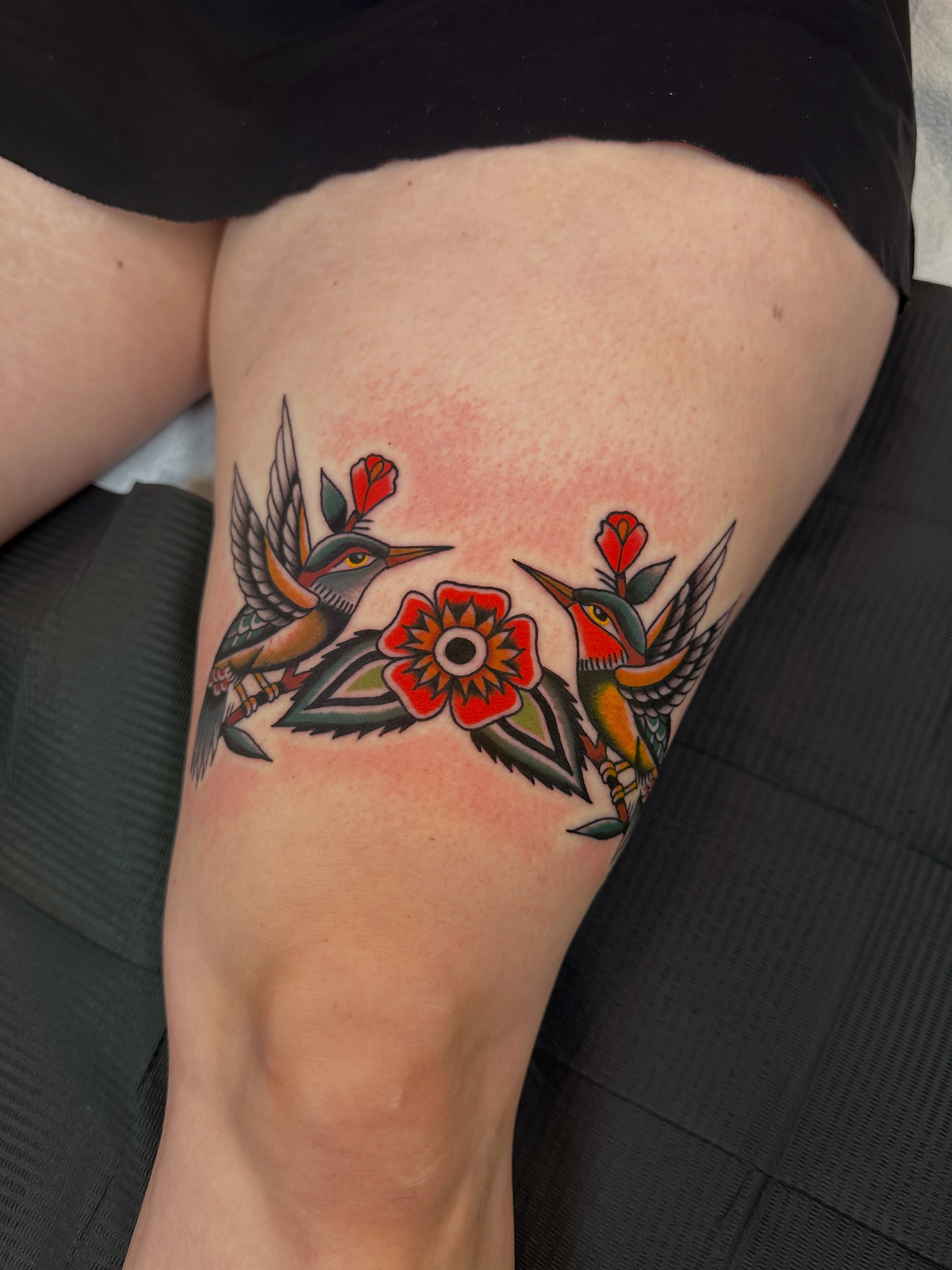 Hummingbirds and flowers American traditional tattoo on the thigh by A.j. Lingerfeldt, Nashville, Tennessee