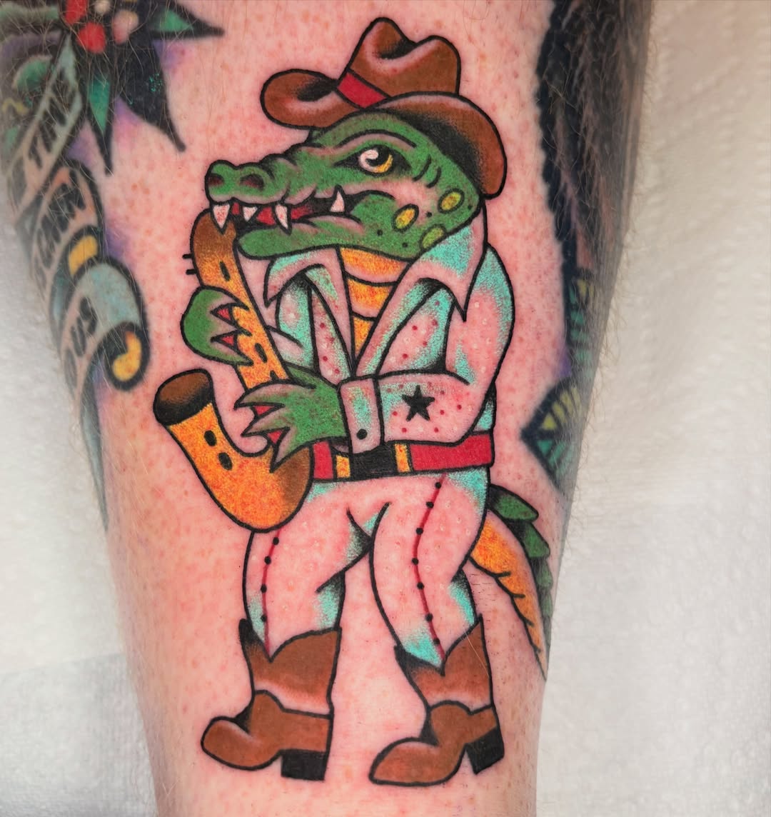 Alligator cowboy American traditional tattoo on the forearm by ๐ต๐๐๐๐ ๐ฎ๐๐๐๐๐๐, New Orleans, Louisiana