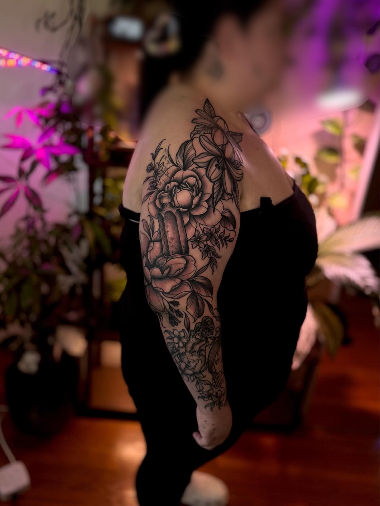 Floral arrangement realism tattoo on the upper arm by Angie Cotton
