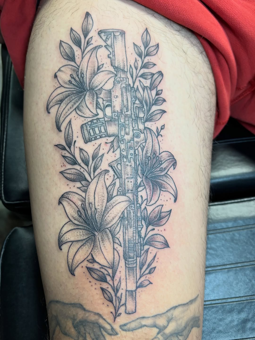 Rifle and lilies fine line tattoo on the thigh by ⚓️Jake