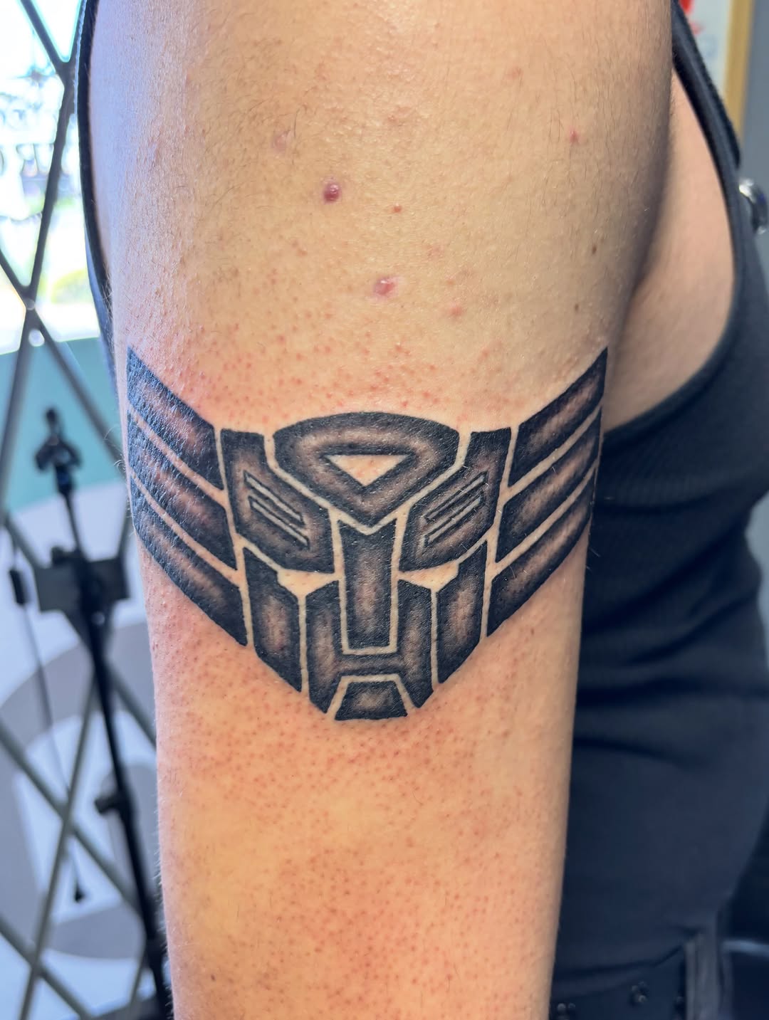 Transformers logo tribal tattoo on the forearm by ⚓️Jake