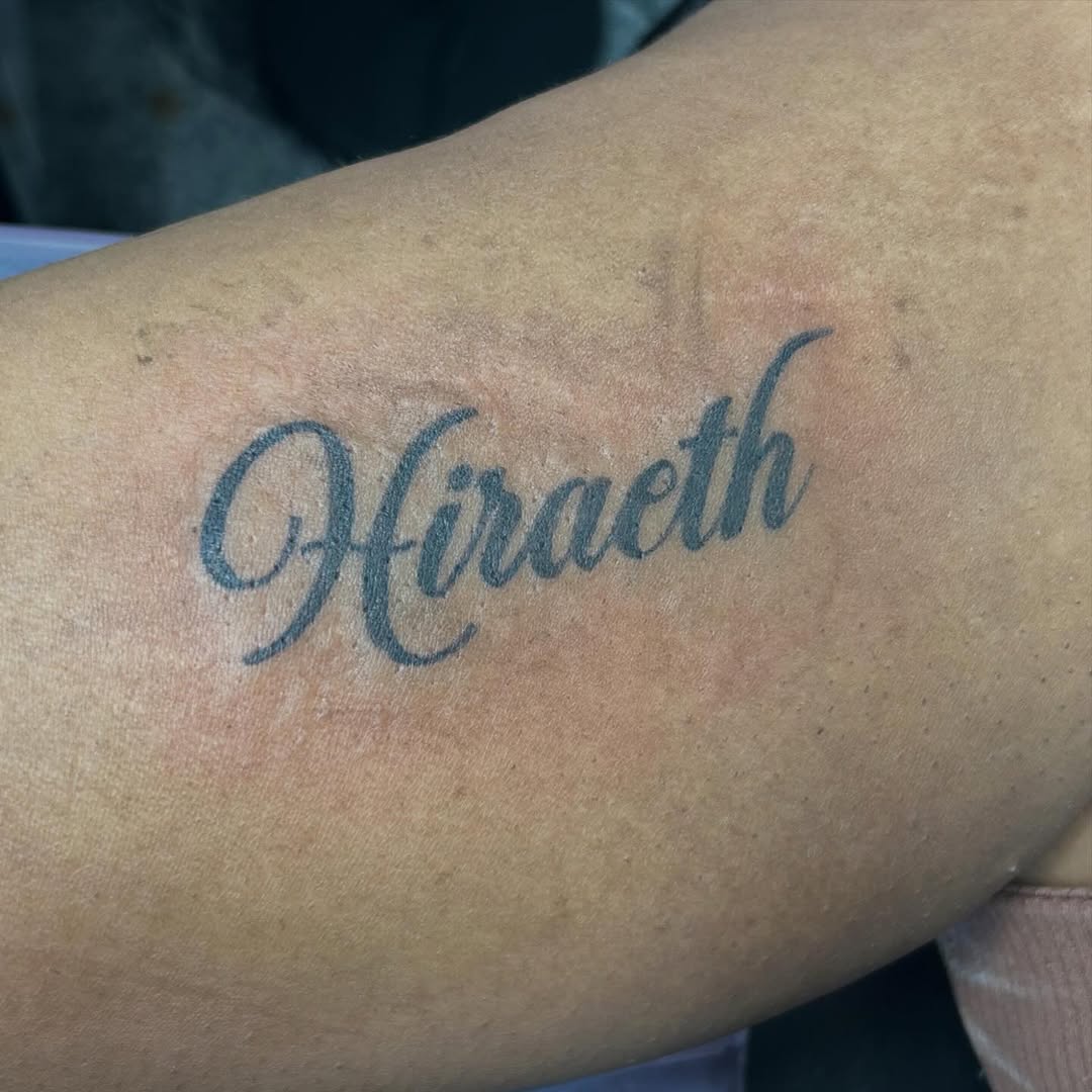 Hiraeth script lettering lettering tattoo on the forearm by Gillian