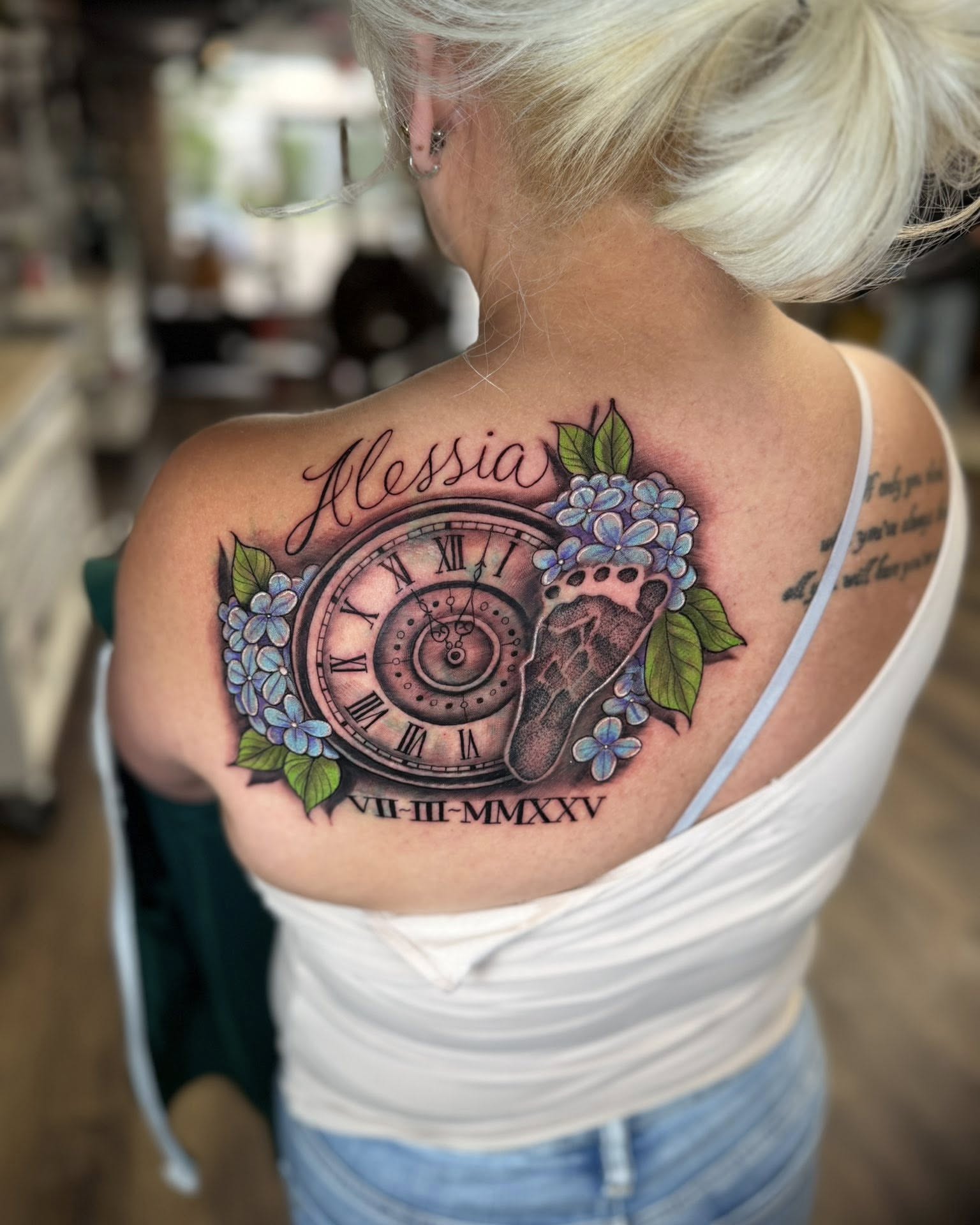 Clock and hydrangea realism tattoo on the shoulder by Chad Meado