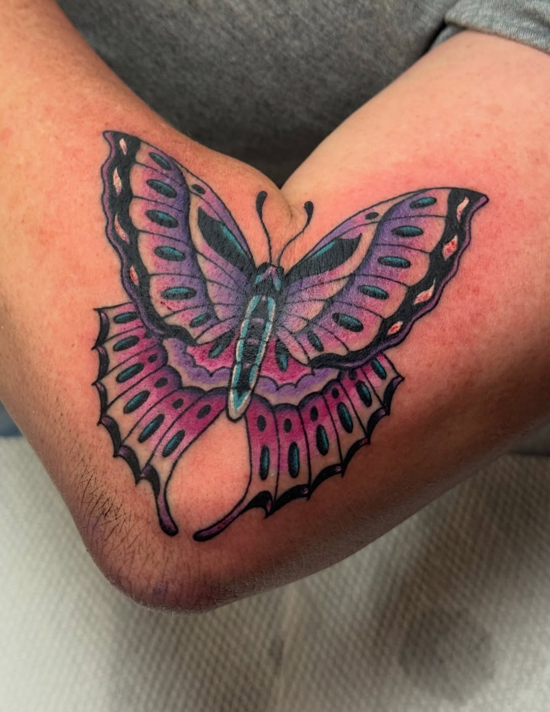 Butterfly fine line tattoo on the forearm by Bre