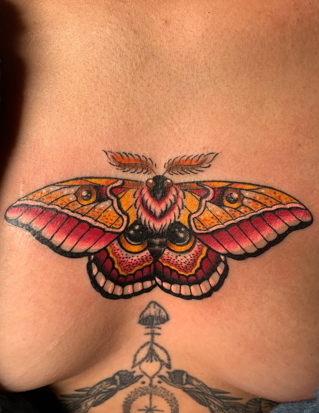Moth fine line tattoo on the back by Bre
