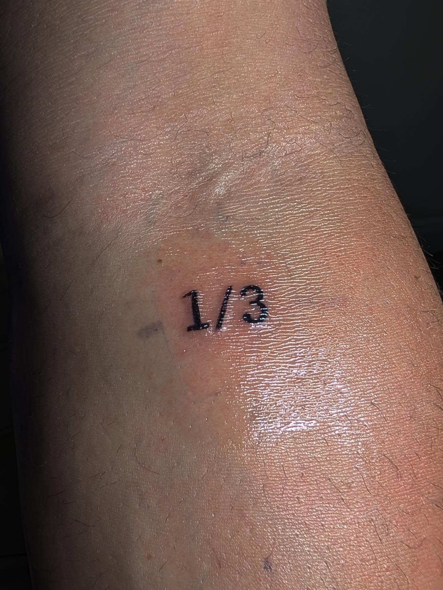 Number lettering script tattoo on the forearm by Tony