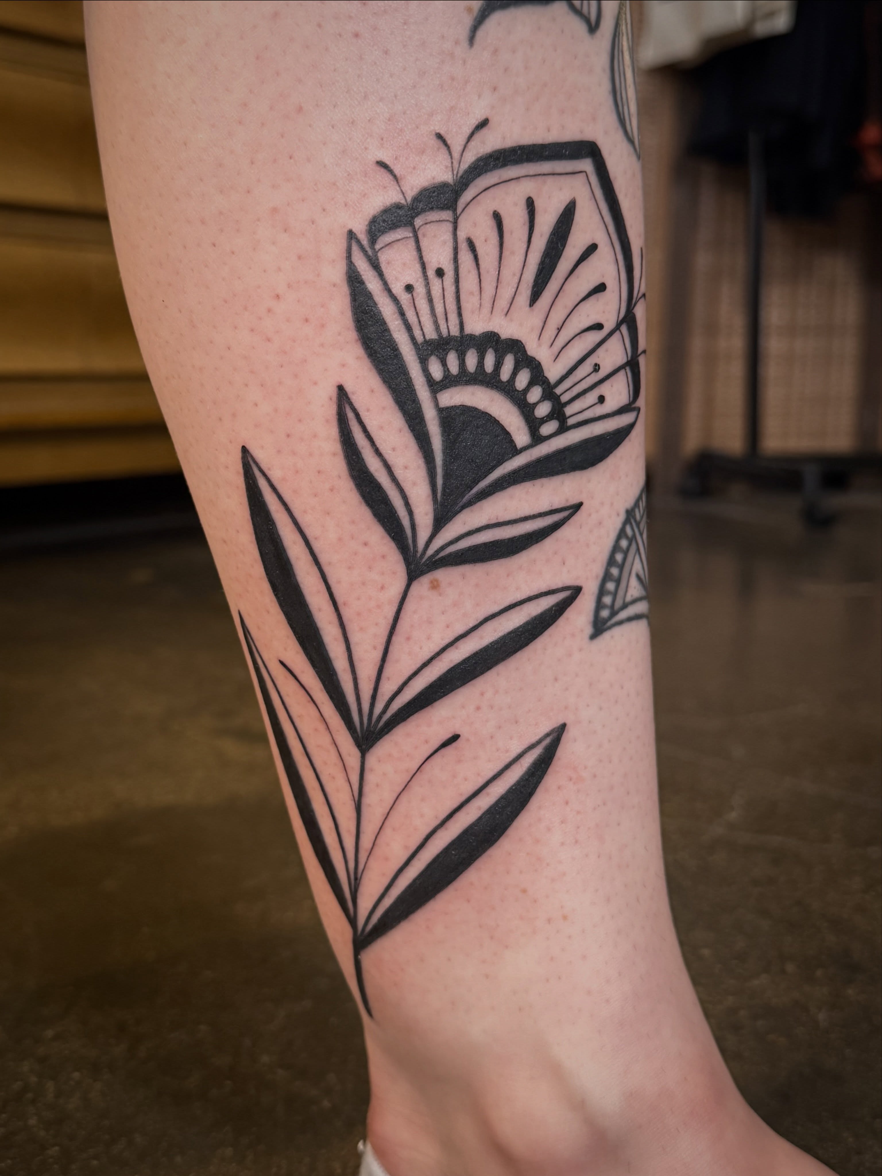 Floral design black and grey tattoo on the forearm by Leah - Tattoo Artist