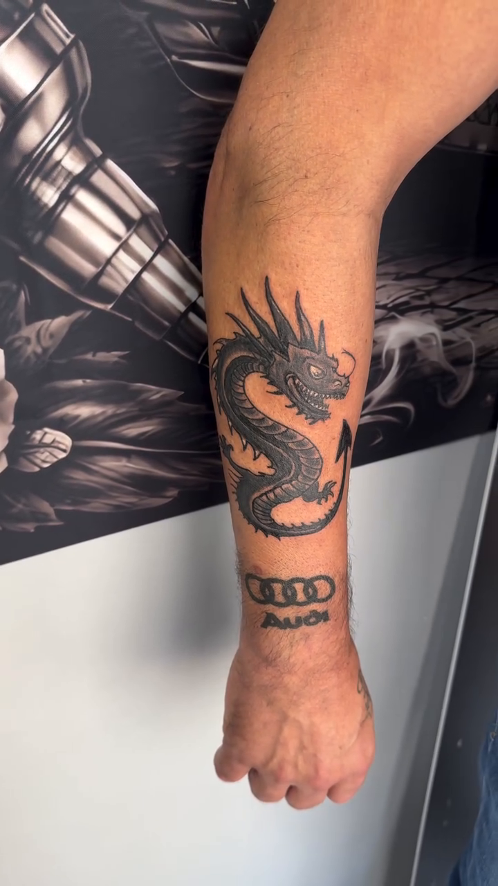 Dragon tattoo with Audi logo Japanese tattoo on the forearm by Salvador Mendoza, Sesto San Giovanni