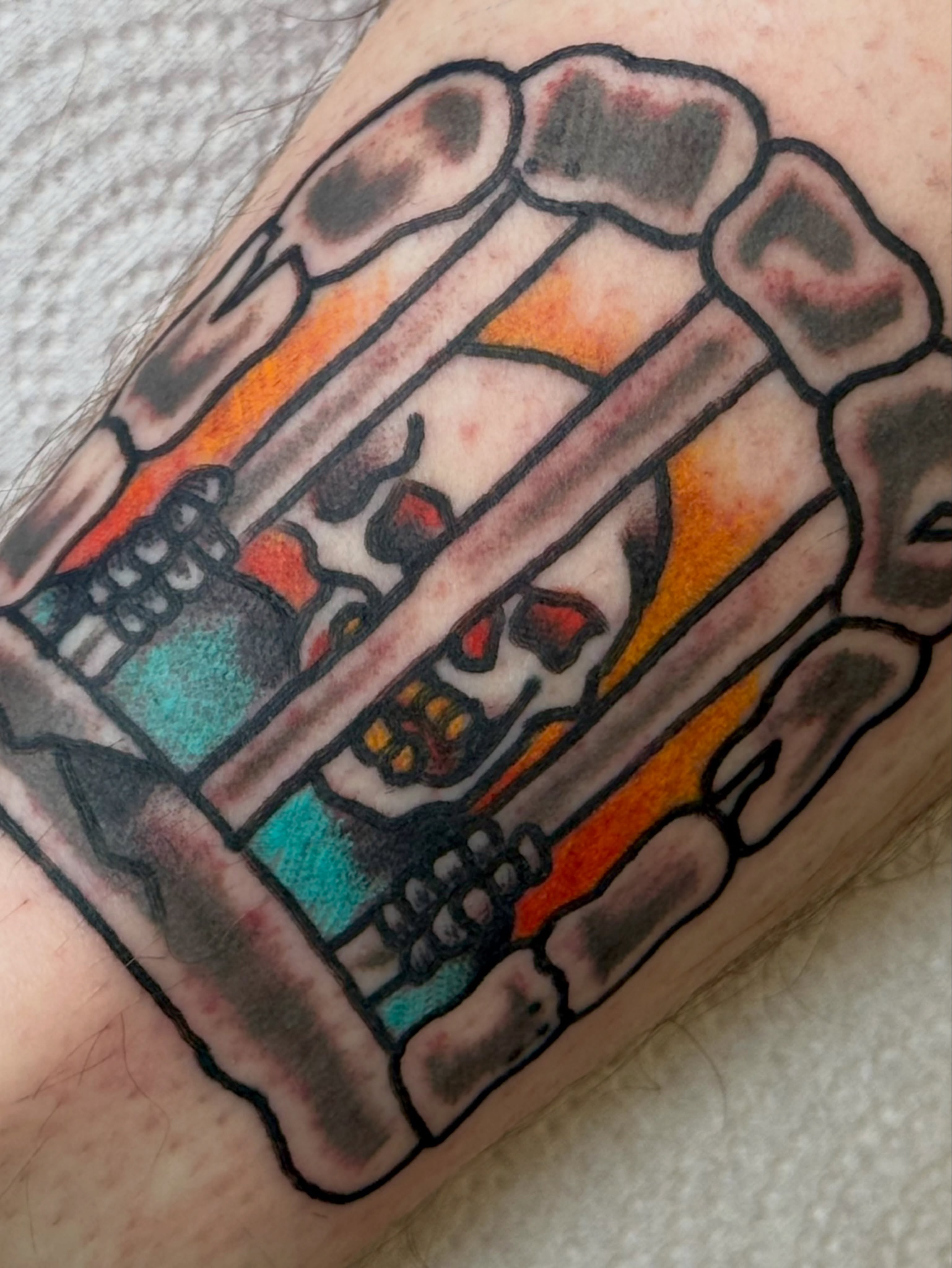 Skull and bones American traditional tattoo on the forearm by Erica Mirella