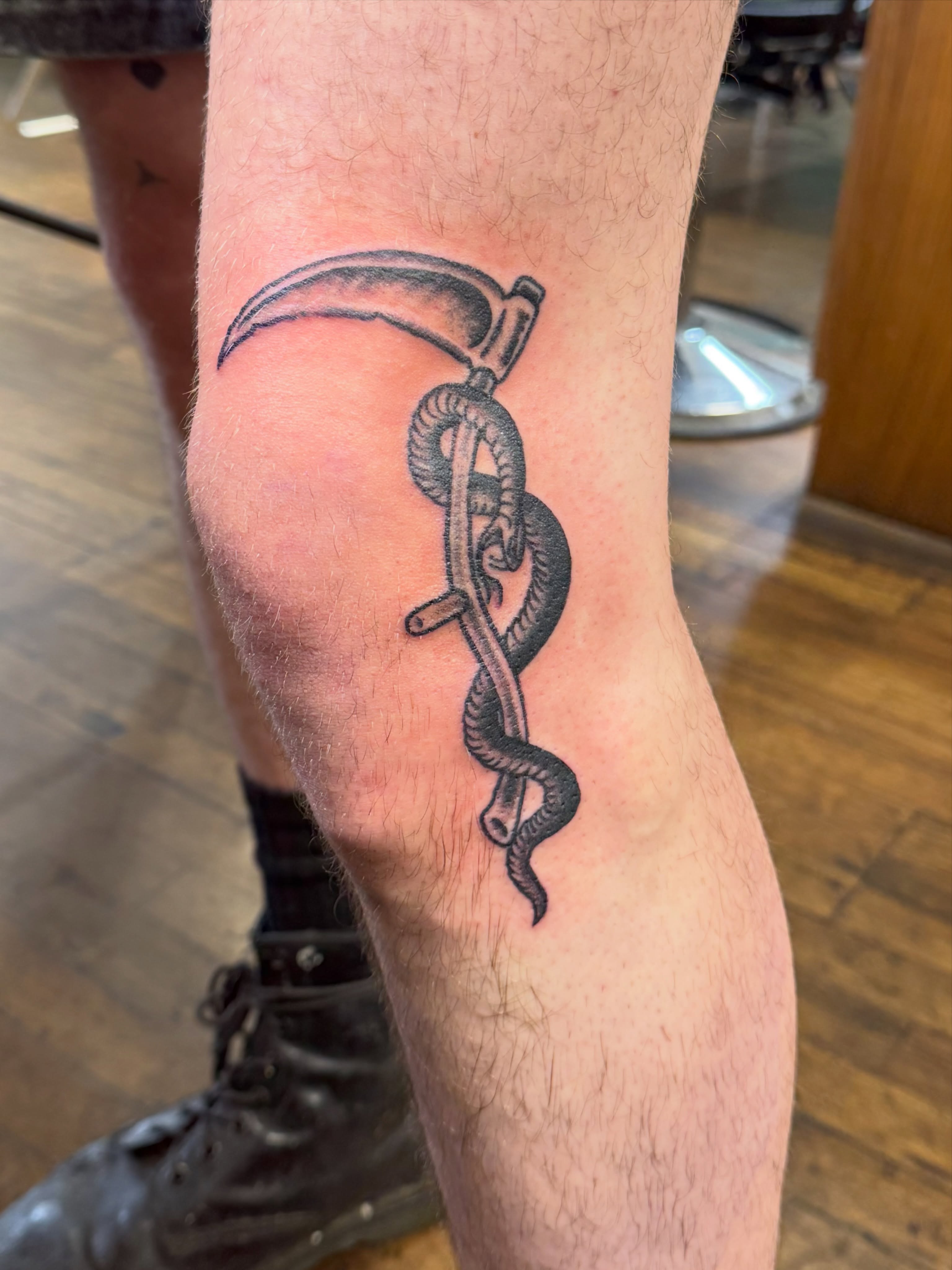 Scythe and snake black and grey tattoo on the forearm by Aaron ulfstam