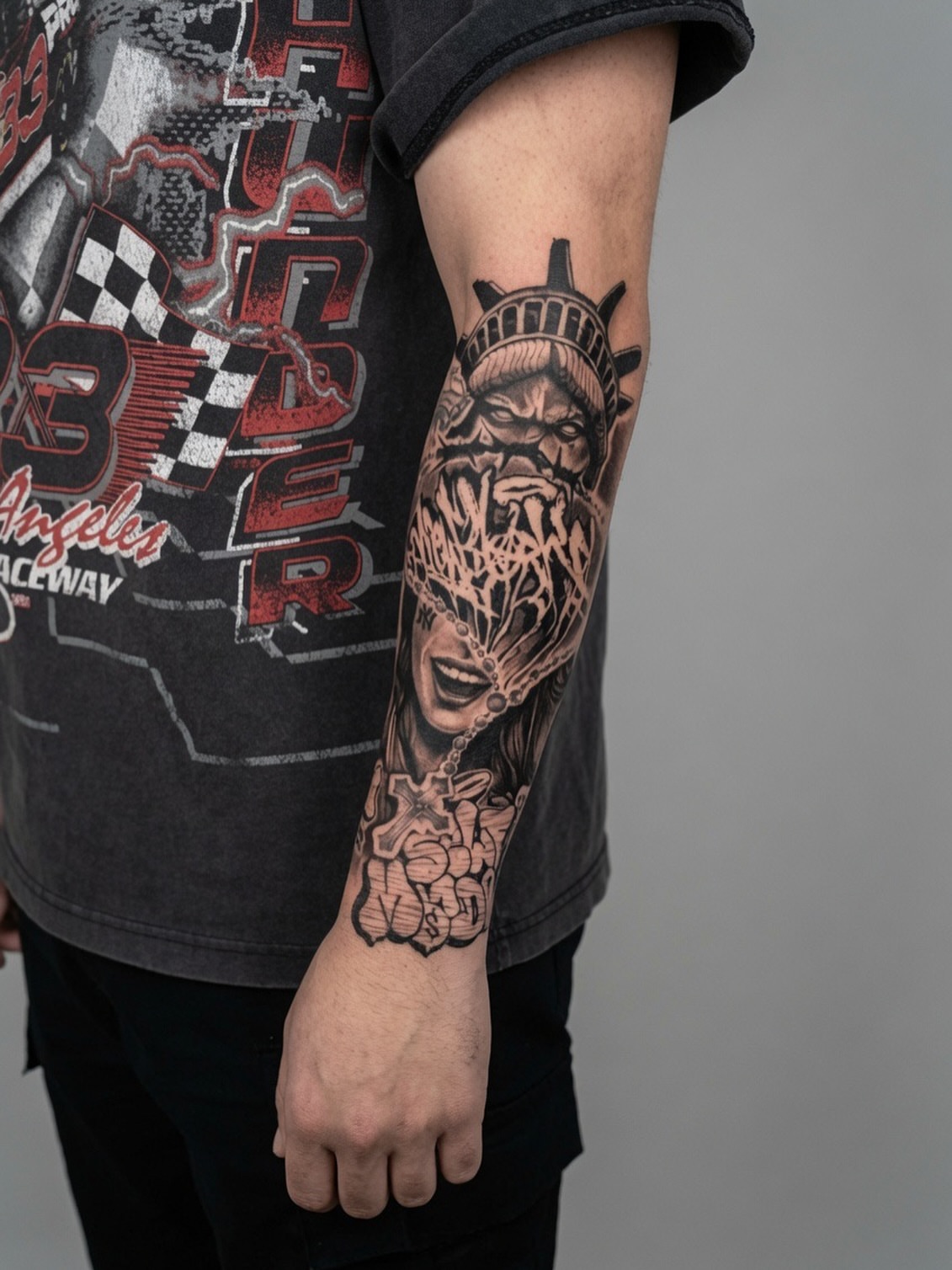 Statue of liberty black and grey tattoo on the forearm by Dmitrii Damoer, New York, New York