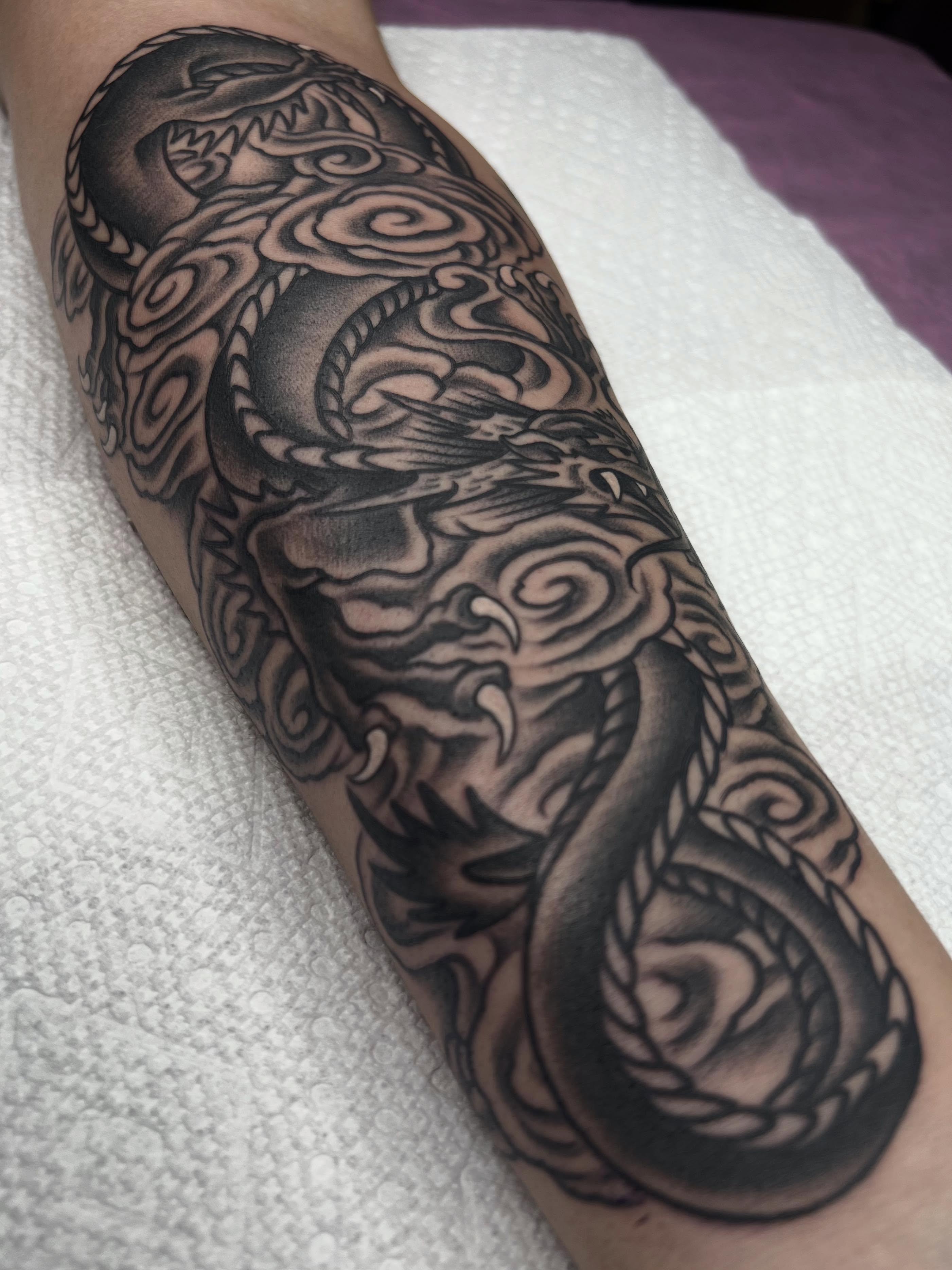 Dragon black and grey tattoo on the forearm by ᴍᴀᴛᴛ ᴀʟᴇxᴀɴᴅᴇʀ
