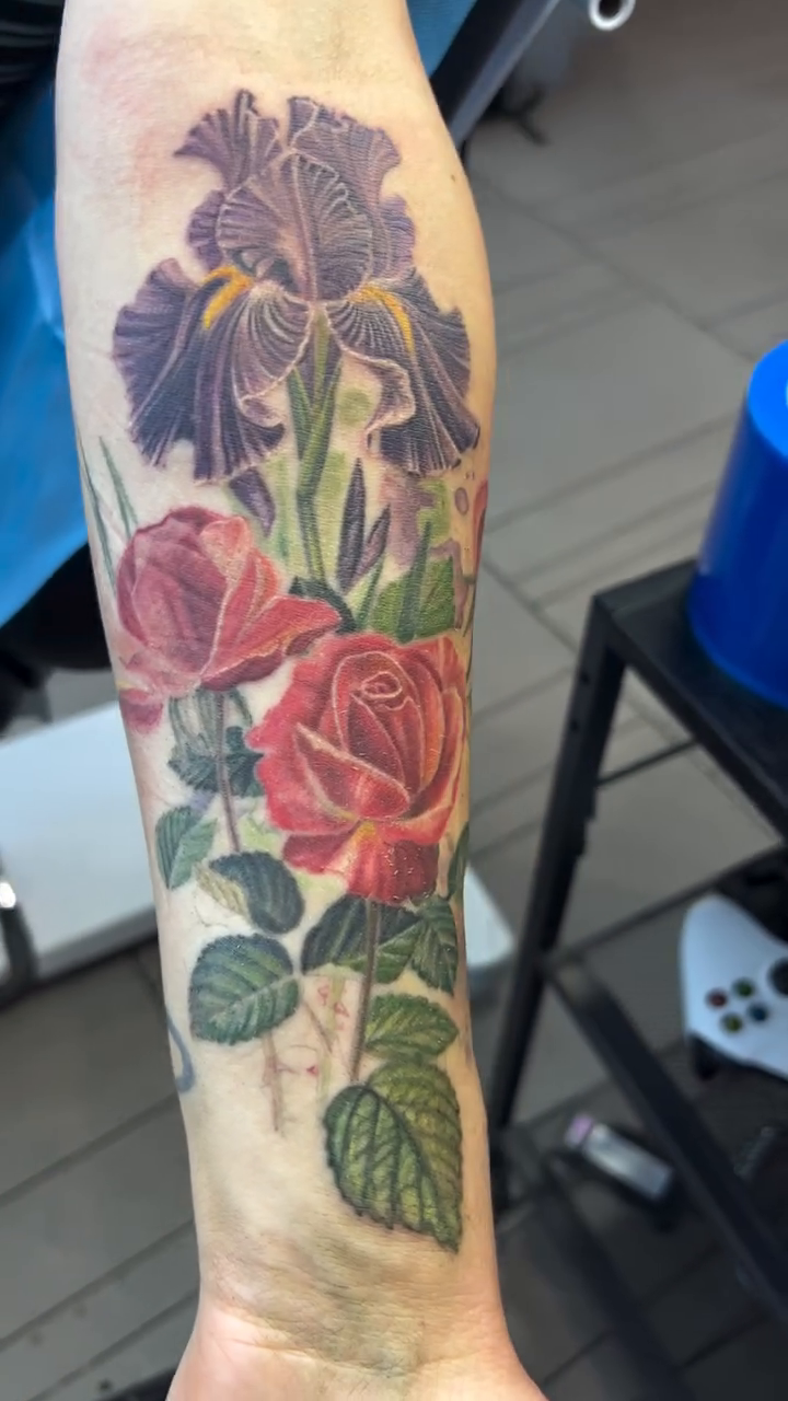 Floral arrangement with roses and irises neo-traditional tattoo on the forearm by Steve Peace Calgary based tattoo artist, Calgary, Alberta