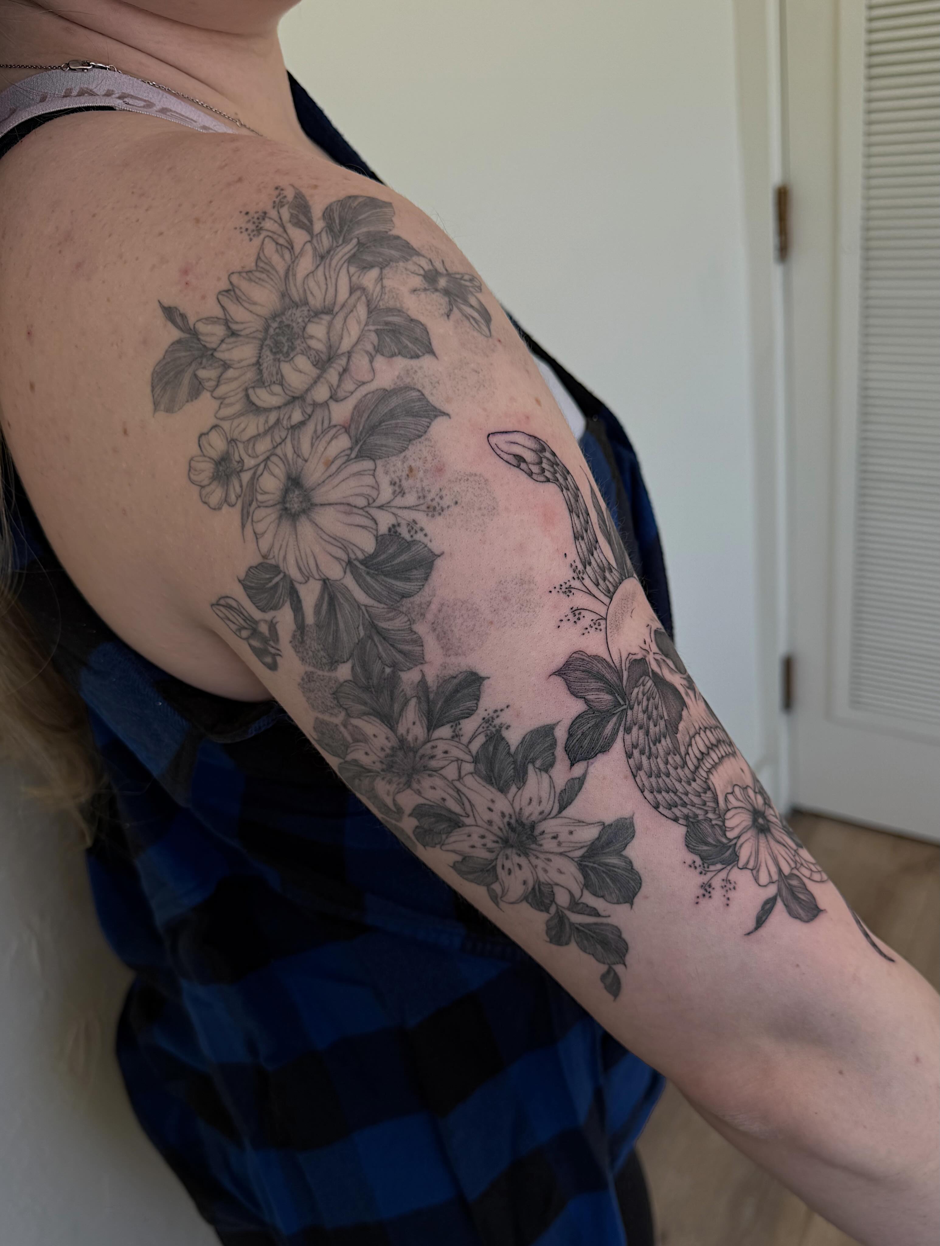 Floral bouquet with bird dotwork tattoo on the upper arm by Shelby Lynn Bayles, Ogden, Utah