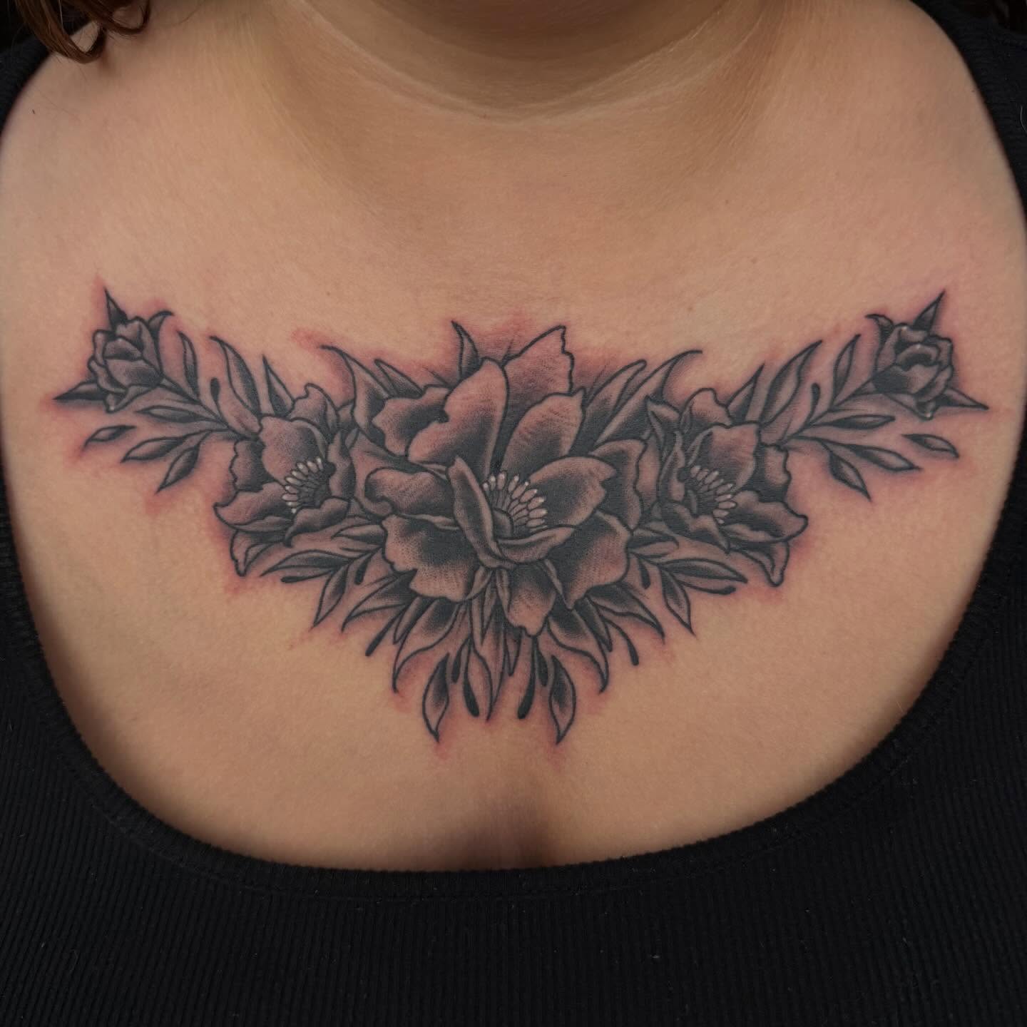 Floral arrangement black and grey tattoo on the chest by Mike Lachowicz