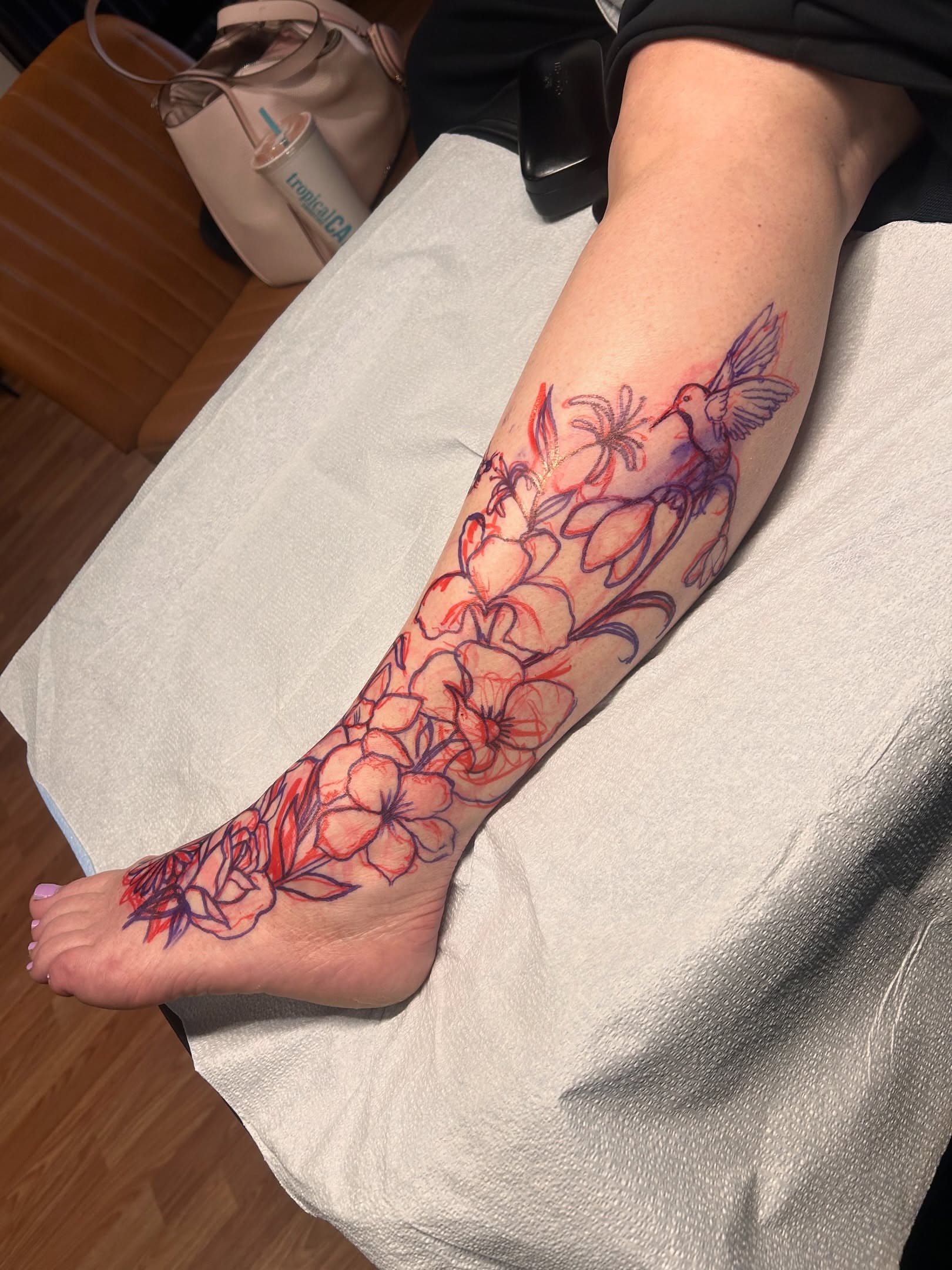 Flowers and hummingbird new school tattoo on the leg by Tori Magill