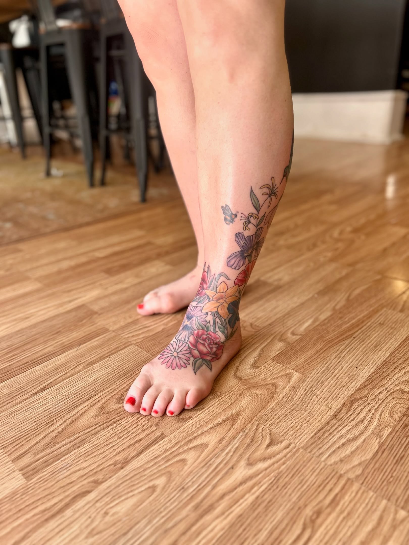 Floral arrangement new school tattoo on the calf by Tori Magill